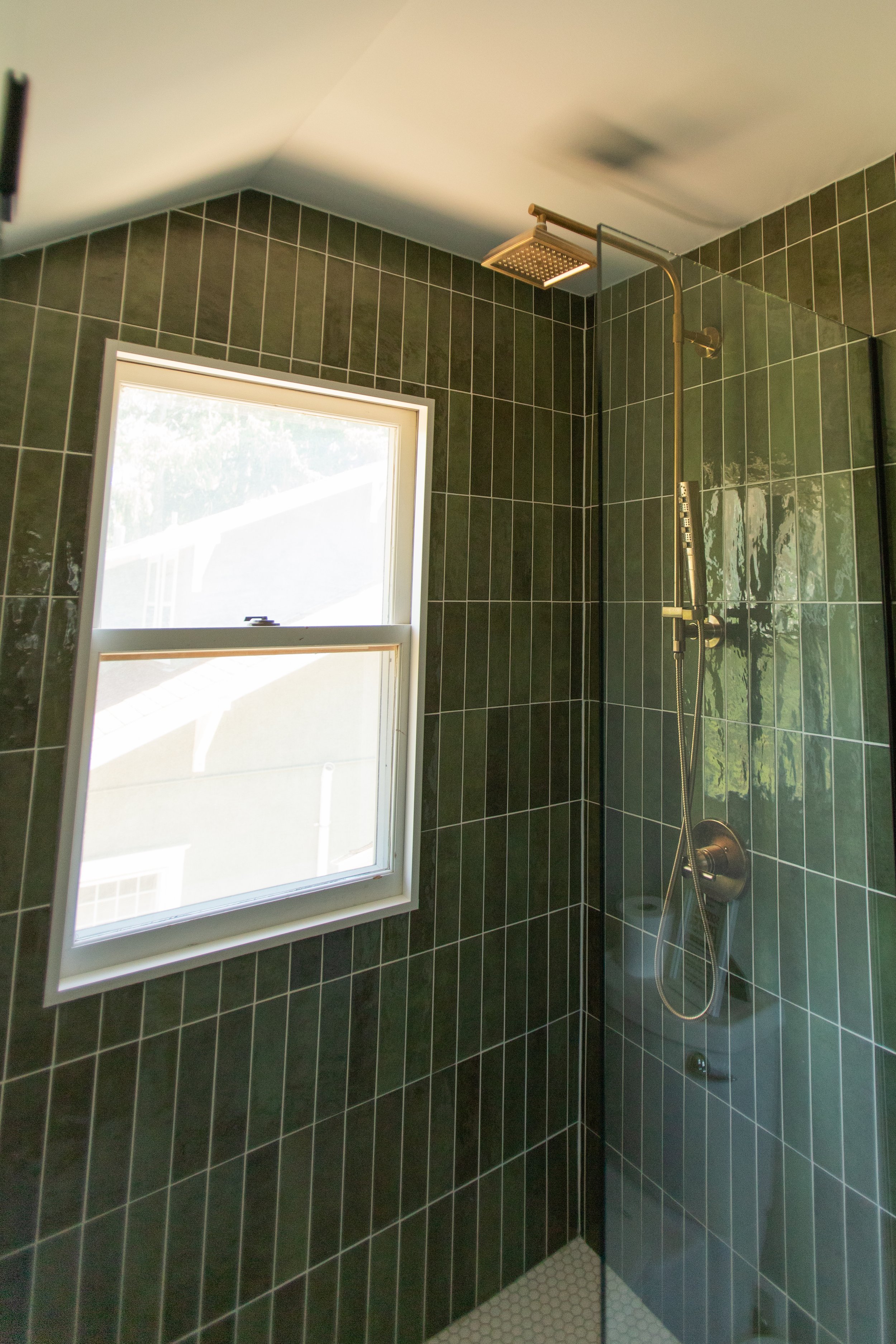 1920 Bathroom Remodel, custom wood vanity, brushed gold hardware, brushed gold sconces, modern design, mixed metal finishes, green subway tile, white hexagon floor tile, Lincoln Nebraska, professional contractors, remodeling and renovations.