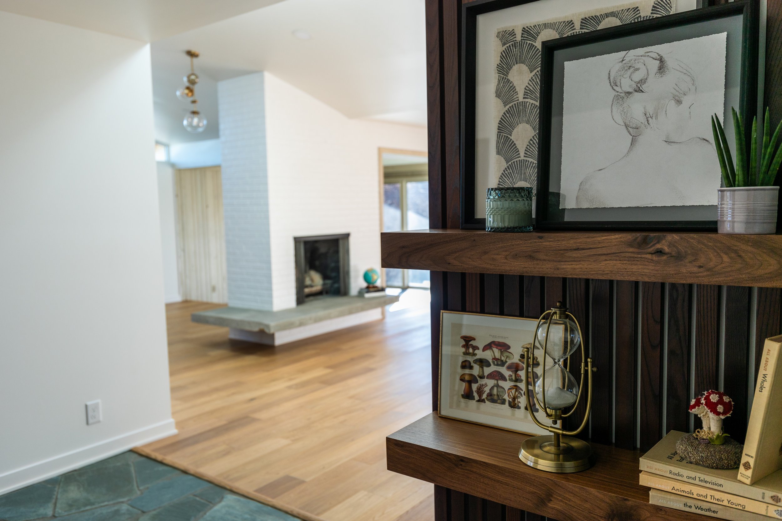 1956 Remodel, mid century modern design, brick fireplace, floating shelves, wood floors, tile floors, wood slat wall, craftsmanship, custom design.