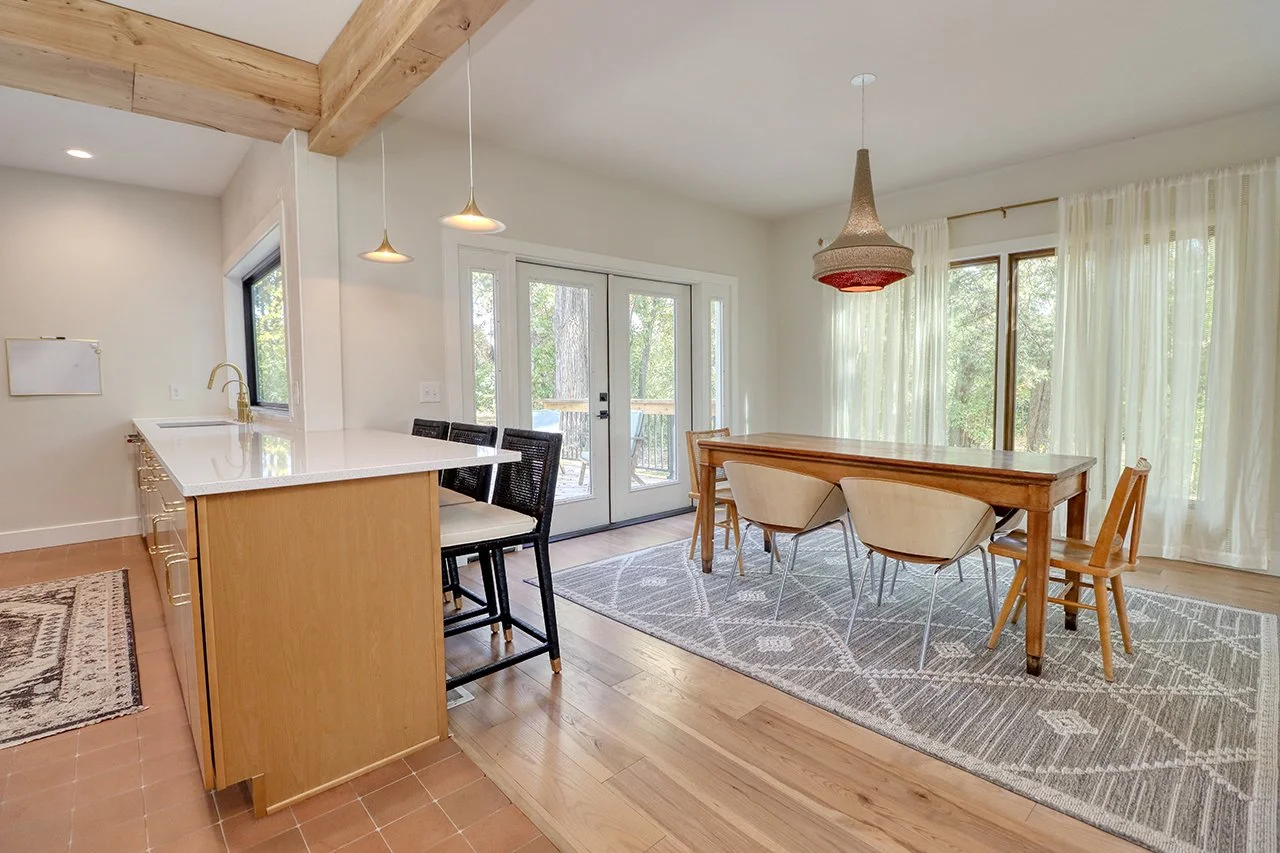 Forest House Remodel, whole home remodel, dining room, boho chic, wood floors, open plan concept, large windows, patio door, patio access. 