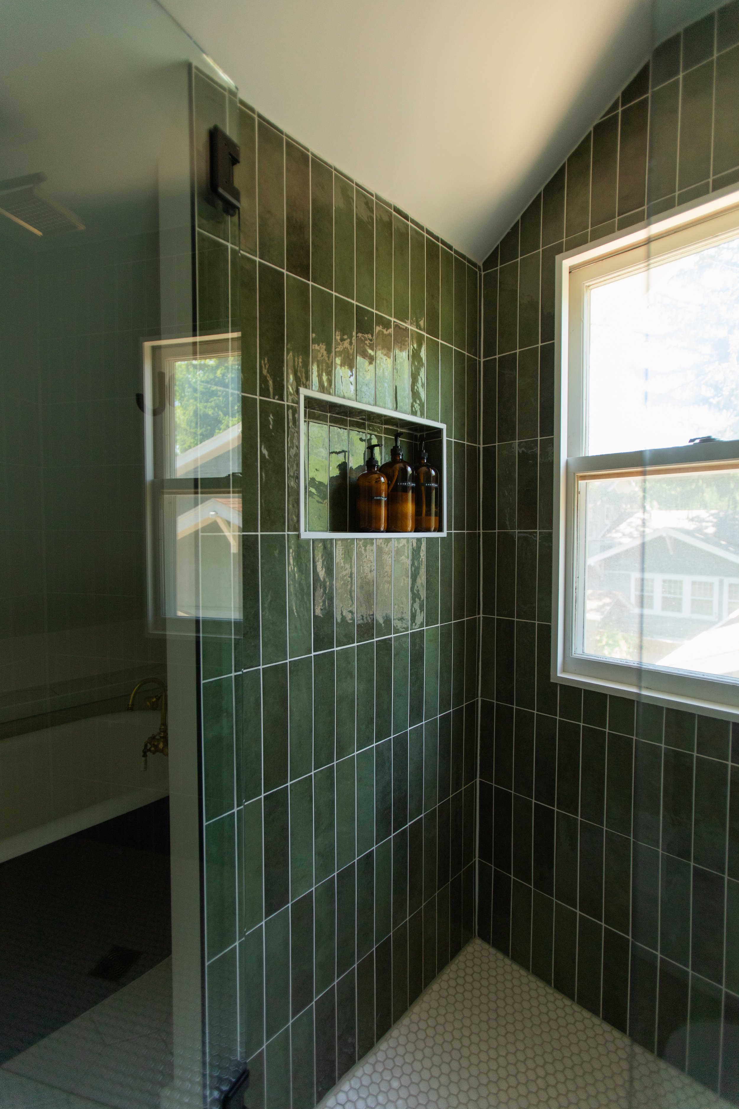 1920 Bathroom Remodel, custom wood vanity, brushed gold hardware, brushed gold sconces, modern design, mixed metal finishes, green subway tile, white hexagon floor tile, Lincoln Nebraska, professional contractors, remodeling and renovations.