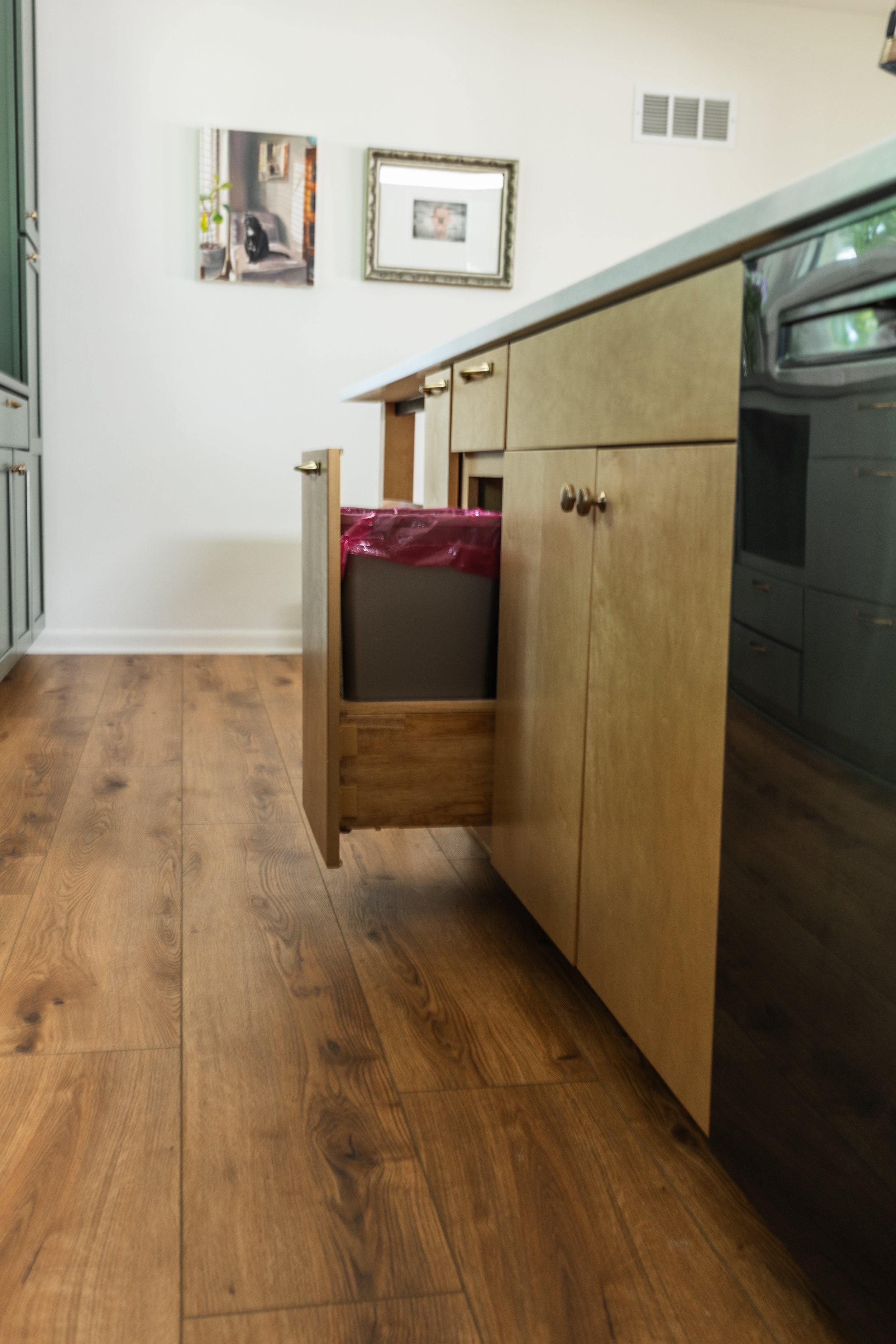 1962 Kitchen Remodel, dark green cabinets, white quartz island, wooden floors, brass hardware, wood cabinets, custom hood, floating shelves, dark countertops, open shelving, large windows, craftsmanship, custom cabinets.