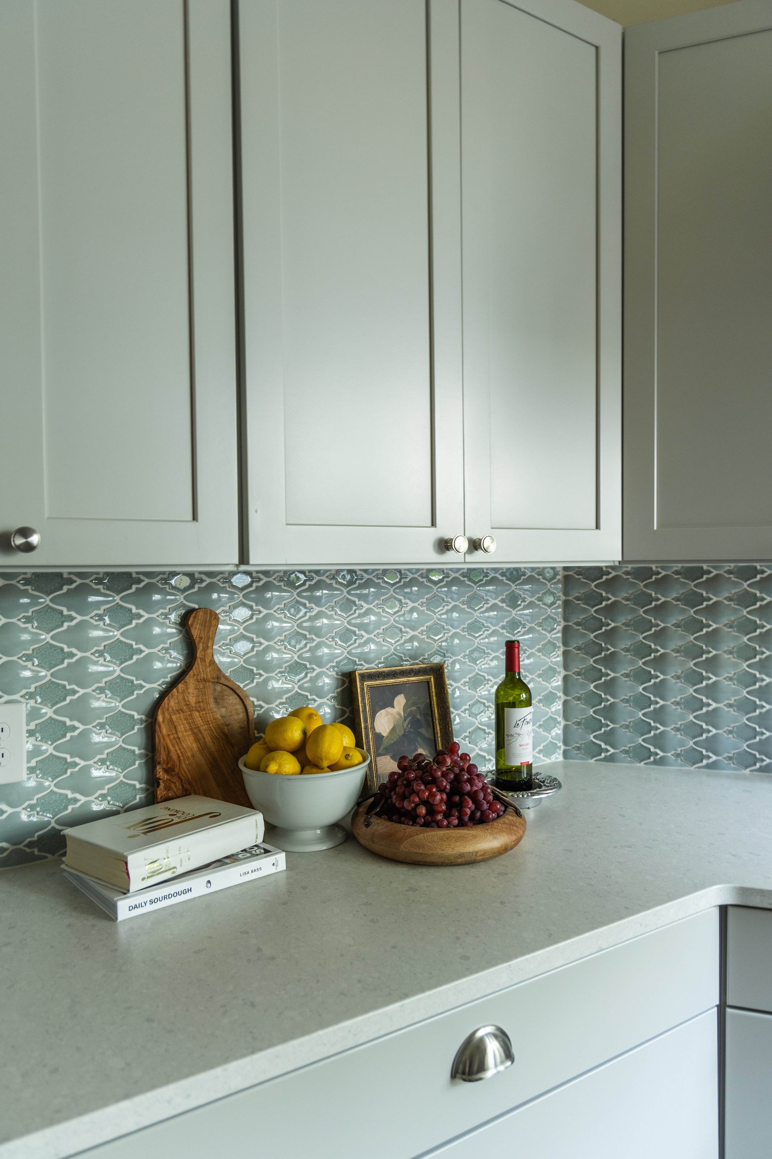 1900 Kitchen Remodel, wood floors, light blue tile backsplash, hardwood floors, open shelving, brushed nickel hardware, wolf oven, stainless steel appliances, custom hood, custom cabinetry, Omaha Nebraska, remodeling and renovations.