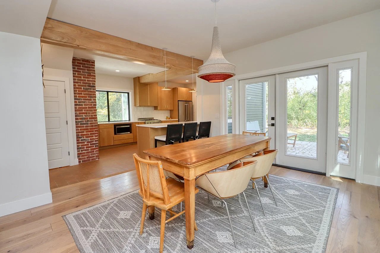 Forest House Remodel, whole home remodel, dining room, boho chic, wood floors, open plan concept, large windows, patio door, patio access. 