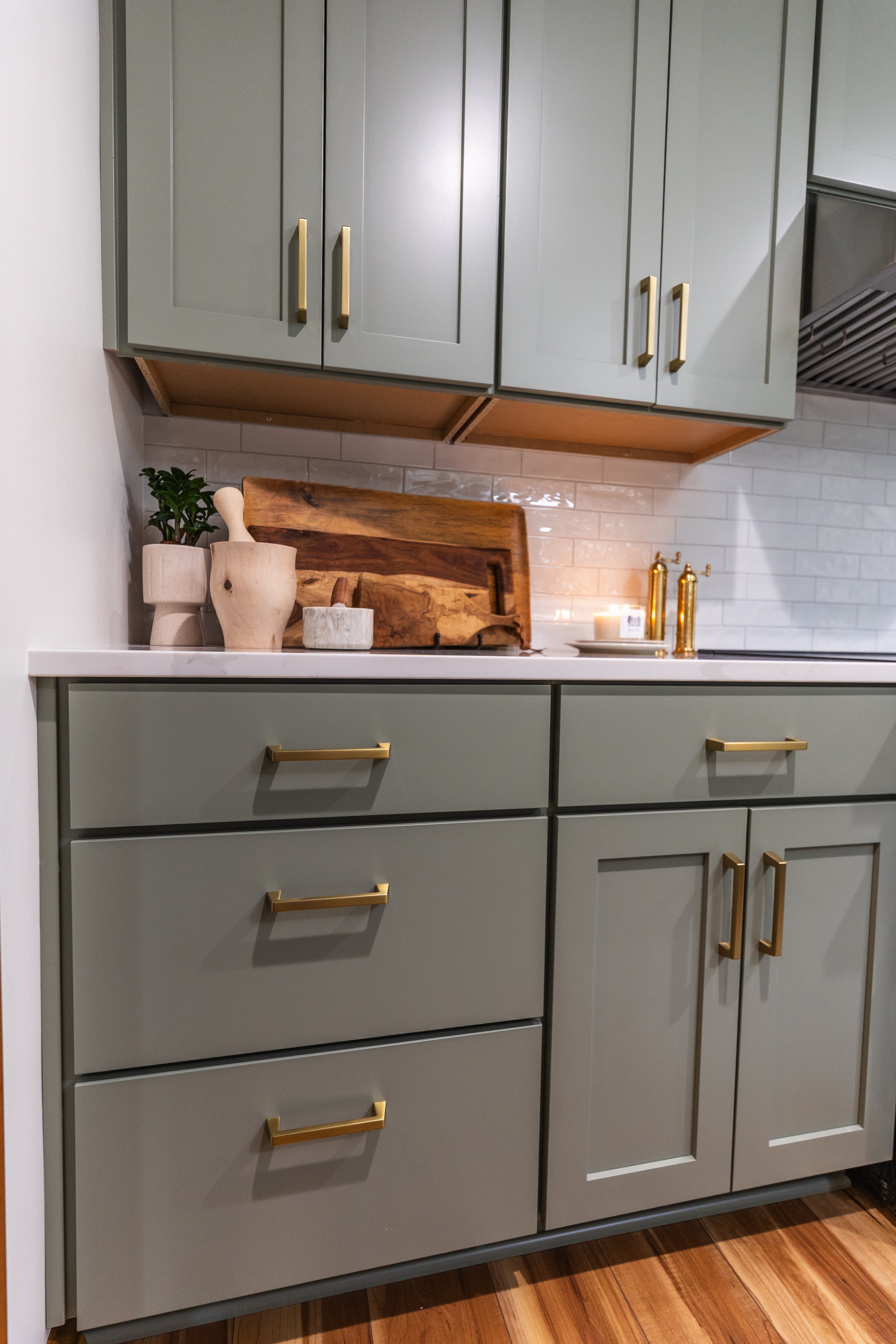 1958 Kitchen Remodel, mid century design, wood floors, stainless steel appliances, sage green cabinets, brushed gold hardware, white quartz countertop, modern light fixtures, Lincoln Nebraska, professional contractors, remodeling and renovations.