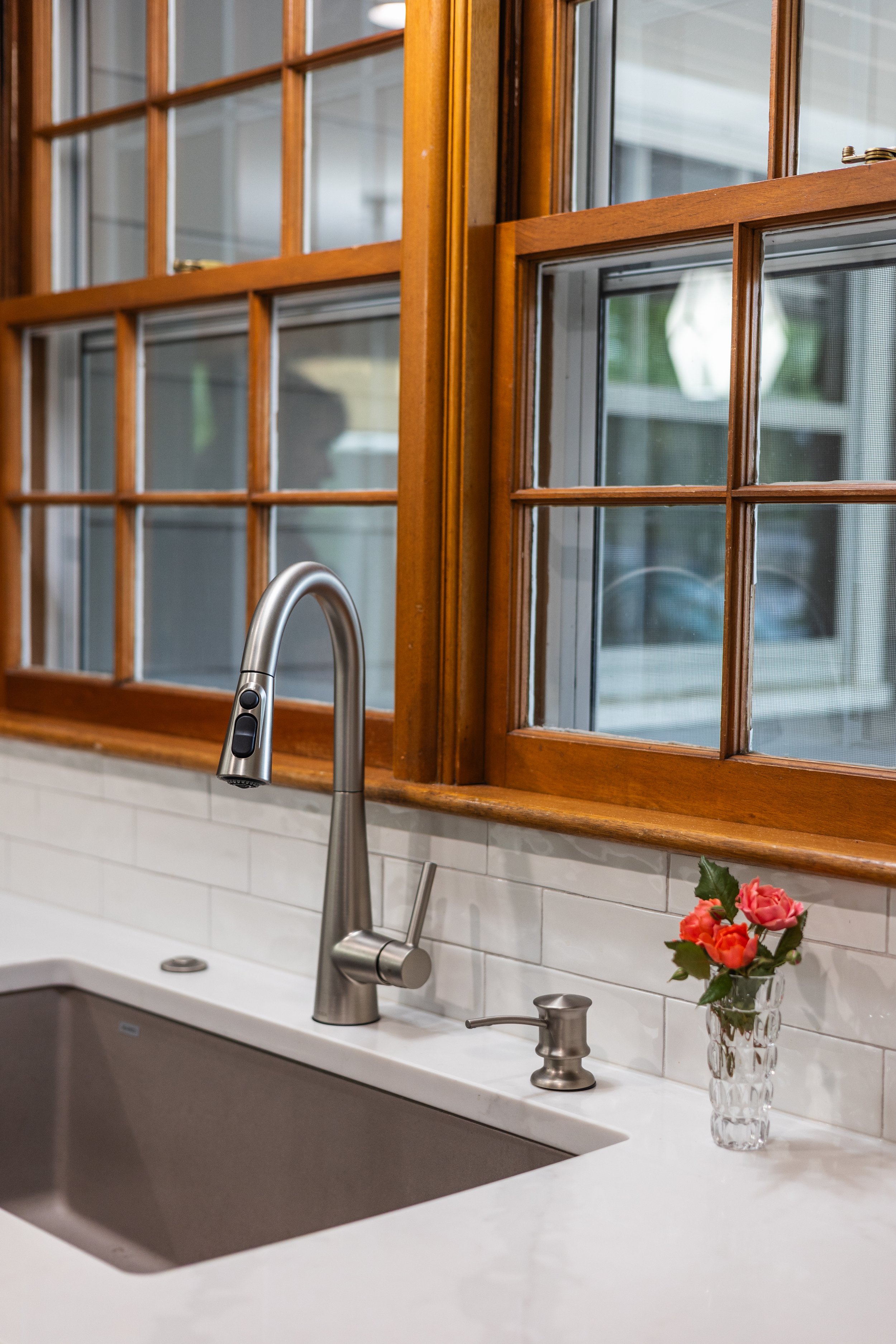 1958 Kitchen Remodel, mid century design, wood floors, stainless steel appliances, sage green cabinets, brushed nickel faucet, white quartz countertop, modern light fixtures, Lincoln Nebraska, professional contractors, remodeling and renovations.