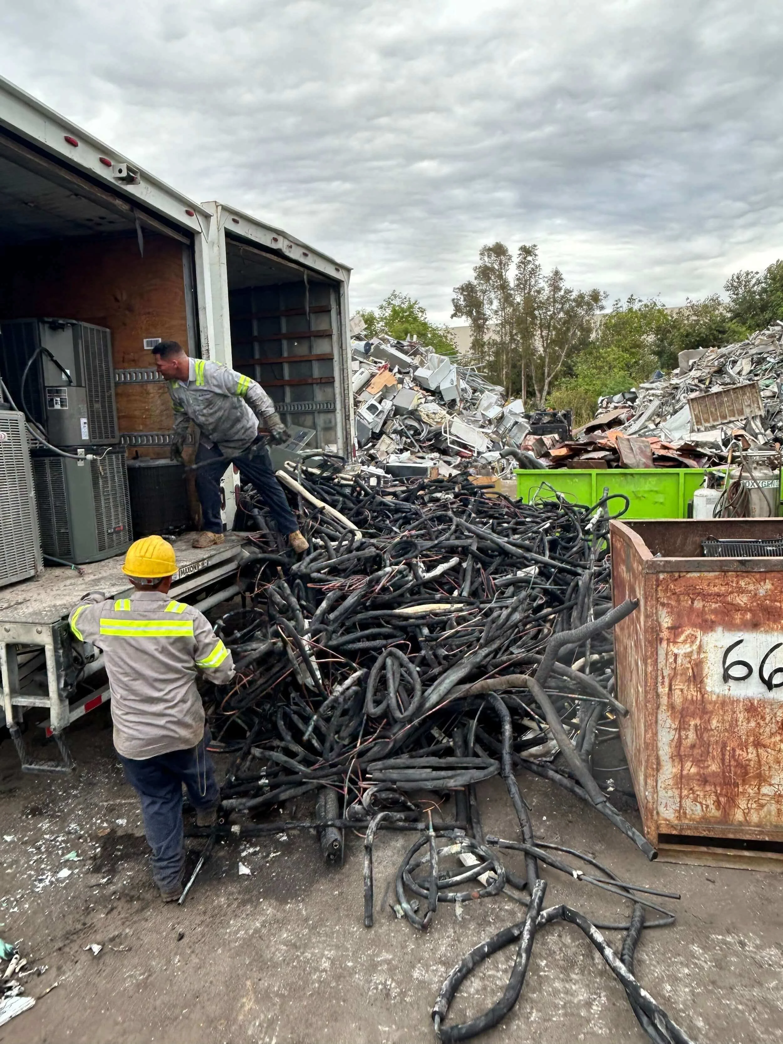workers pulling material out of truck