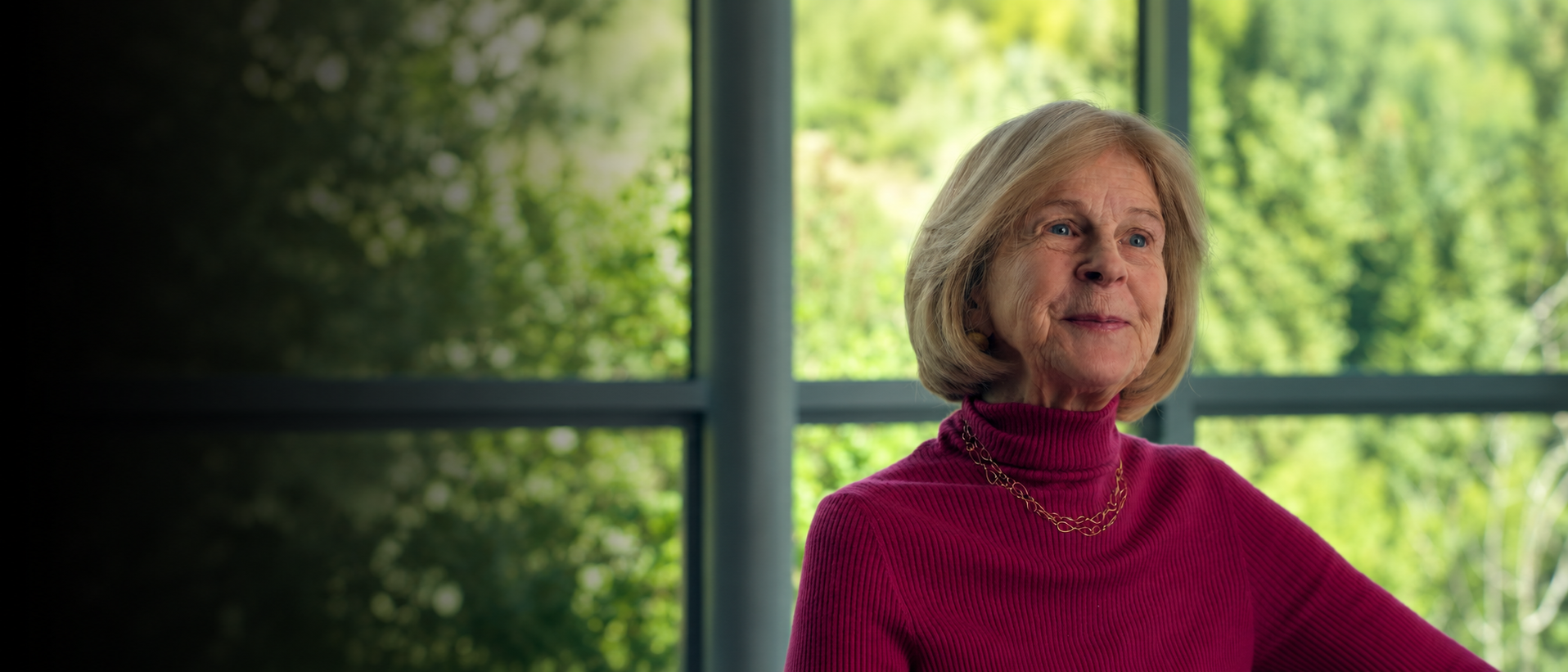 Elaine Pagels in front of window