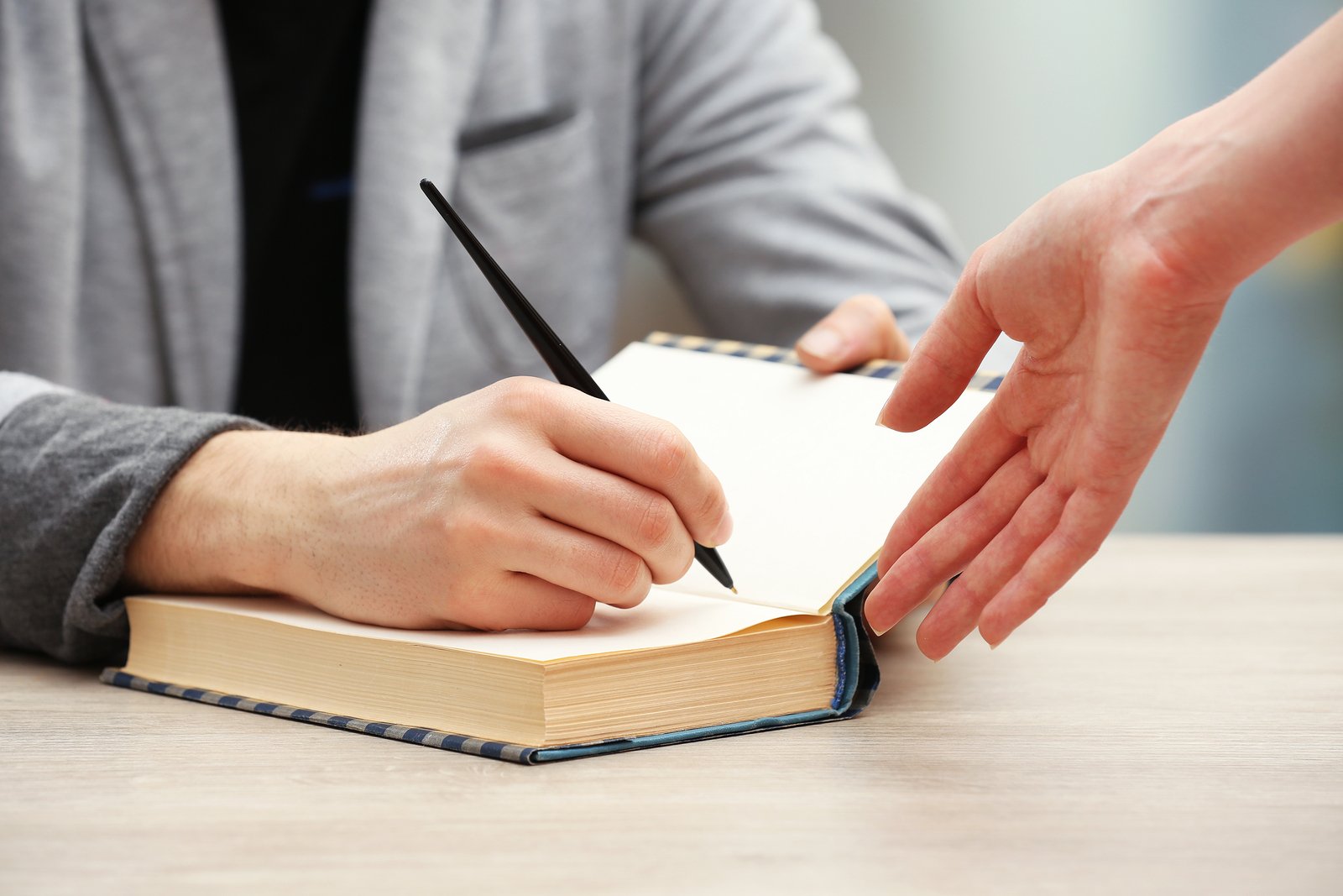 bigstock-Author-signing-autograph-in-ow-83316053.jpg