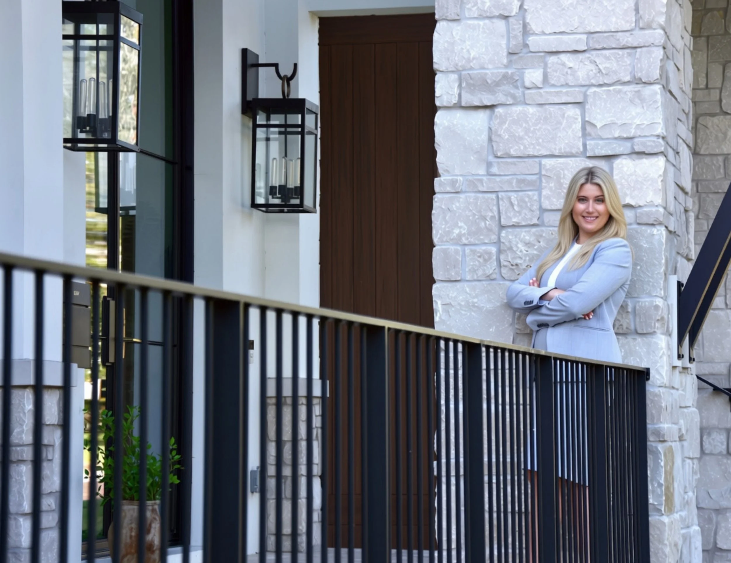 Attorney Silvia Brett standing by a railing with her arms crossed.