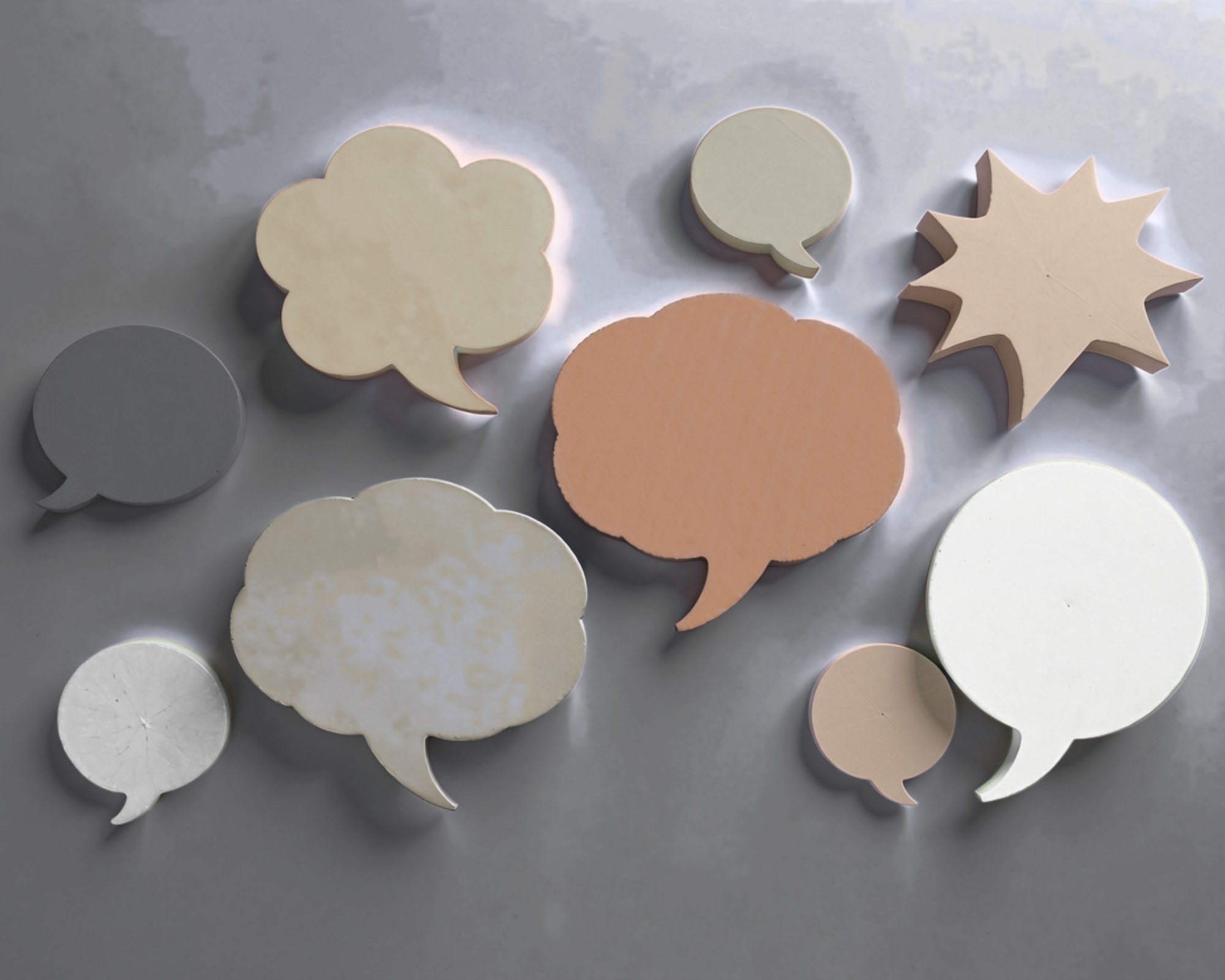 Wooden speech bubble shapes symbolizing communication and conversation.