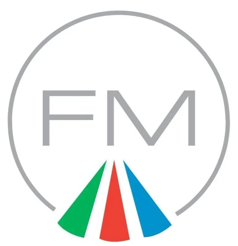 Logo with large gray letters 'FM' inside a gray circle and colorful triangular shapes below in green, red, white, and blue.