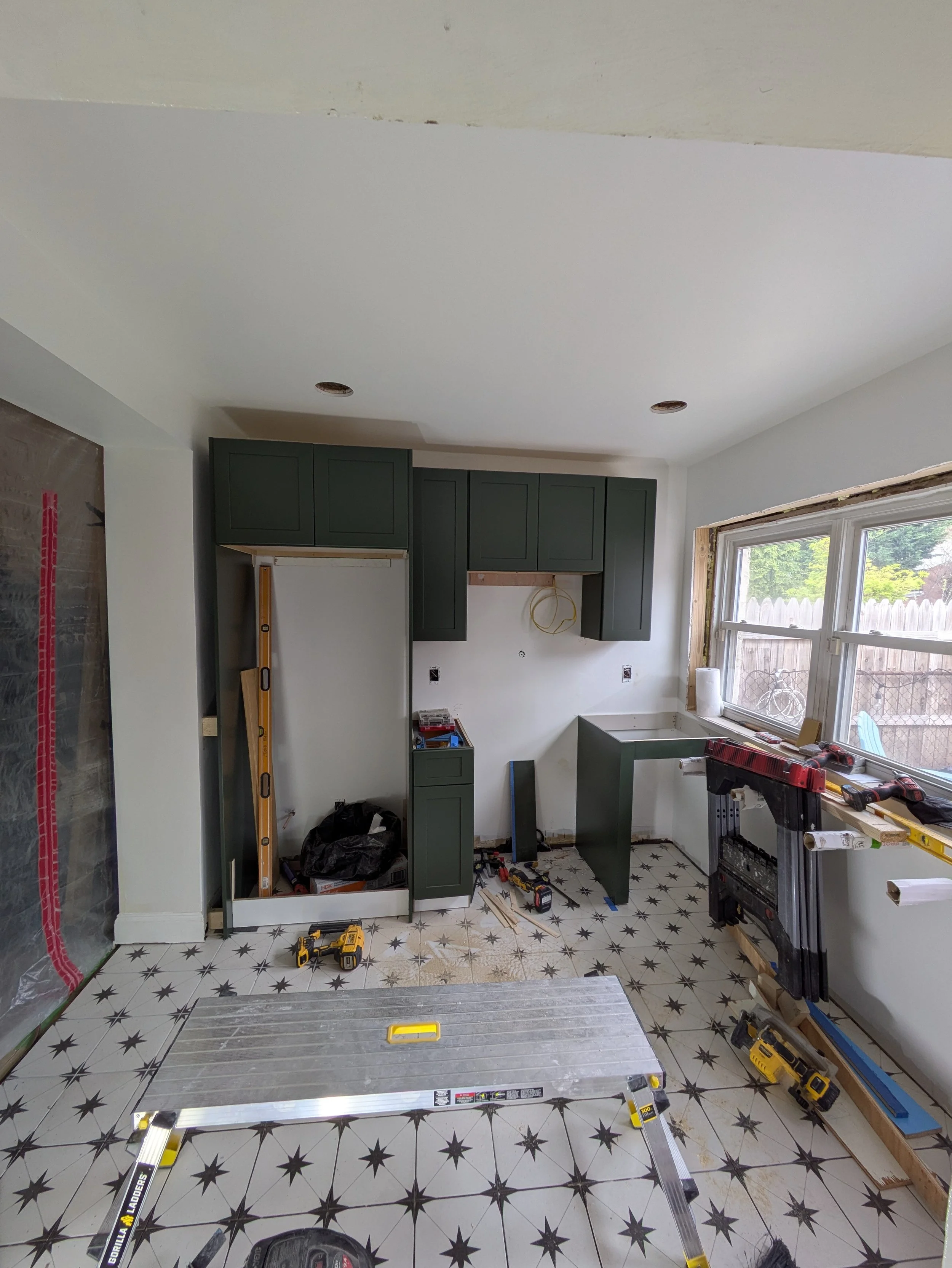 During - Tile floor complete - Installing Cabinets