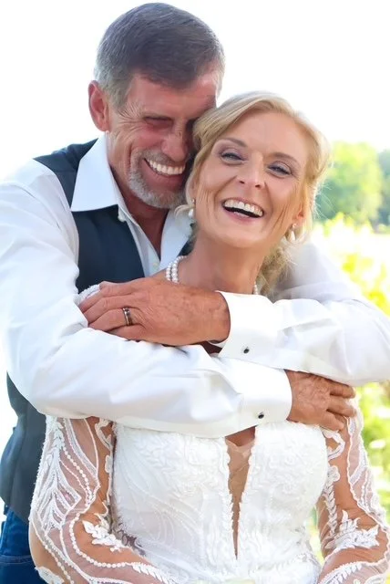 A couple laughs in green garden space