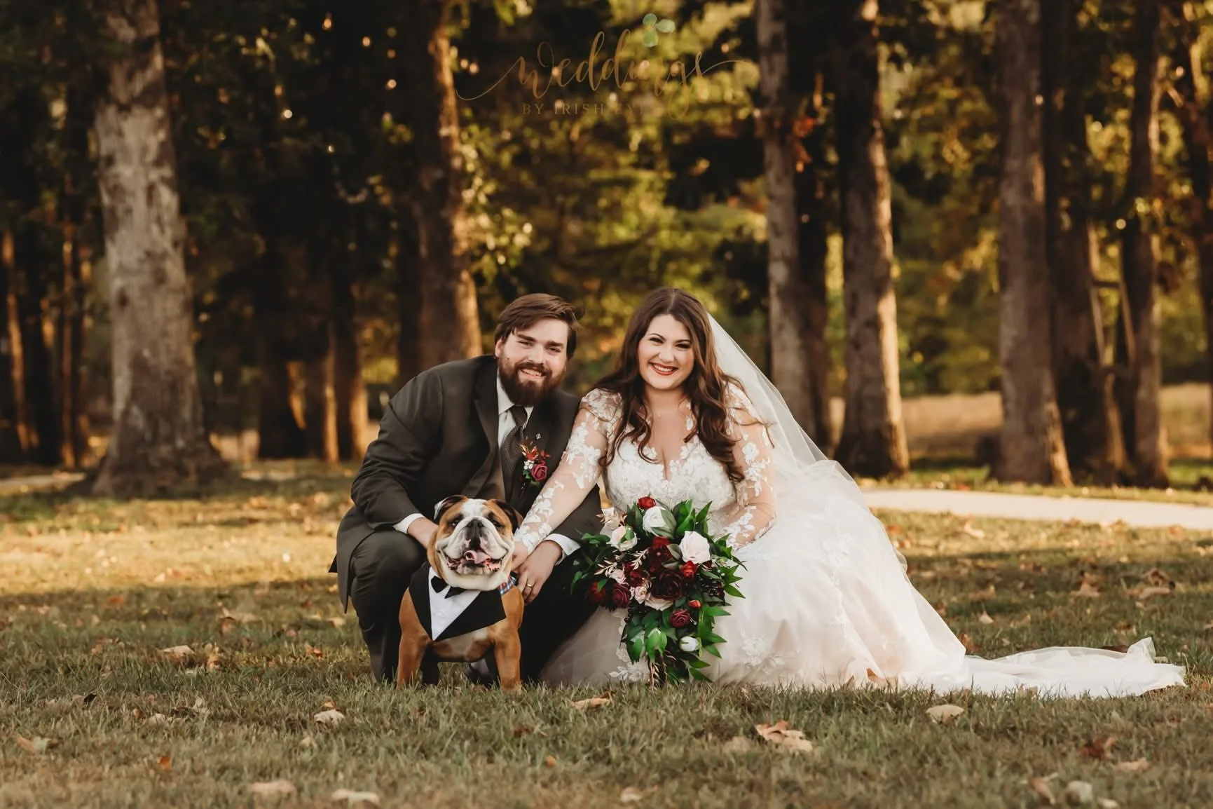 Bulldog and couple by woodland forest ceremony site