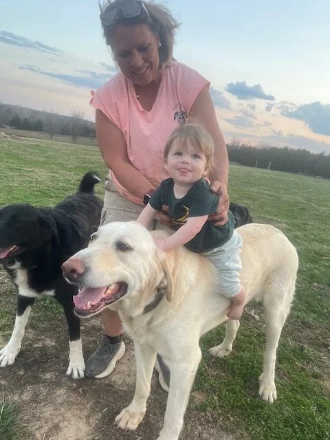Kim with Grandson and Oliver the Big Yellow Dog