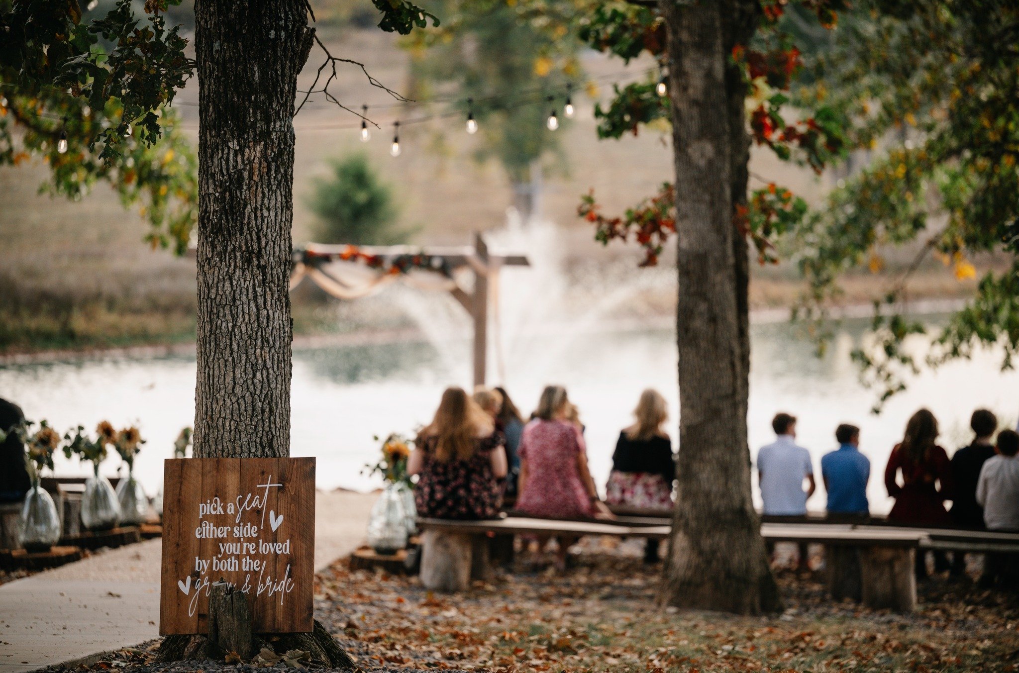 no sides ceremony sign at Berkshire Ridge St. Louis Wedding Venue ceremony site with trees and lake.jpg