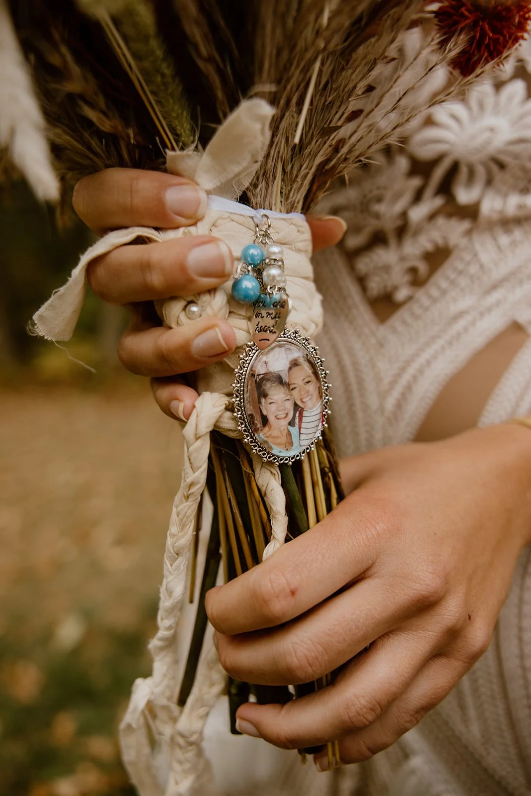 Wedding bouquet with memorial photo locket of bride’s grandmother, meaningful “something old” detail