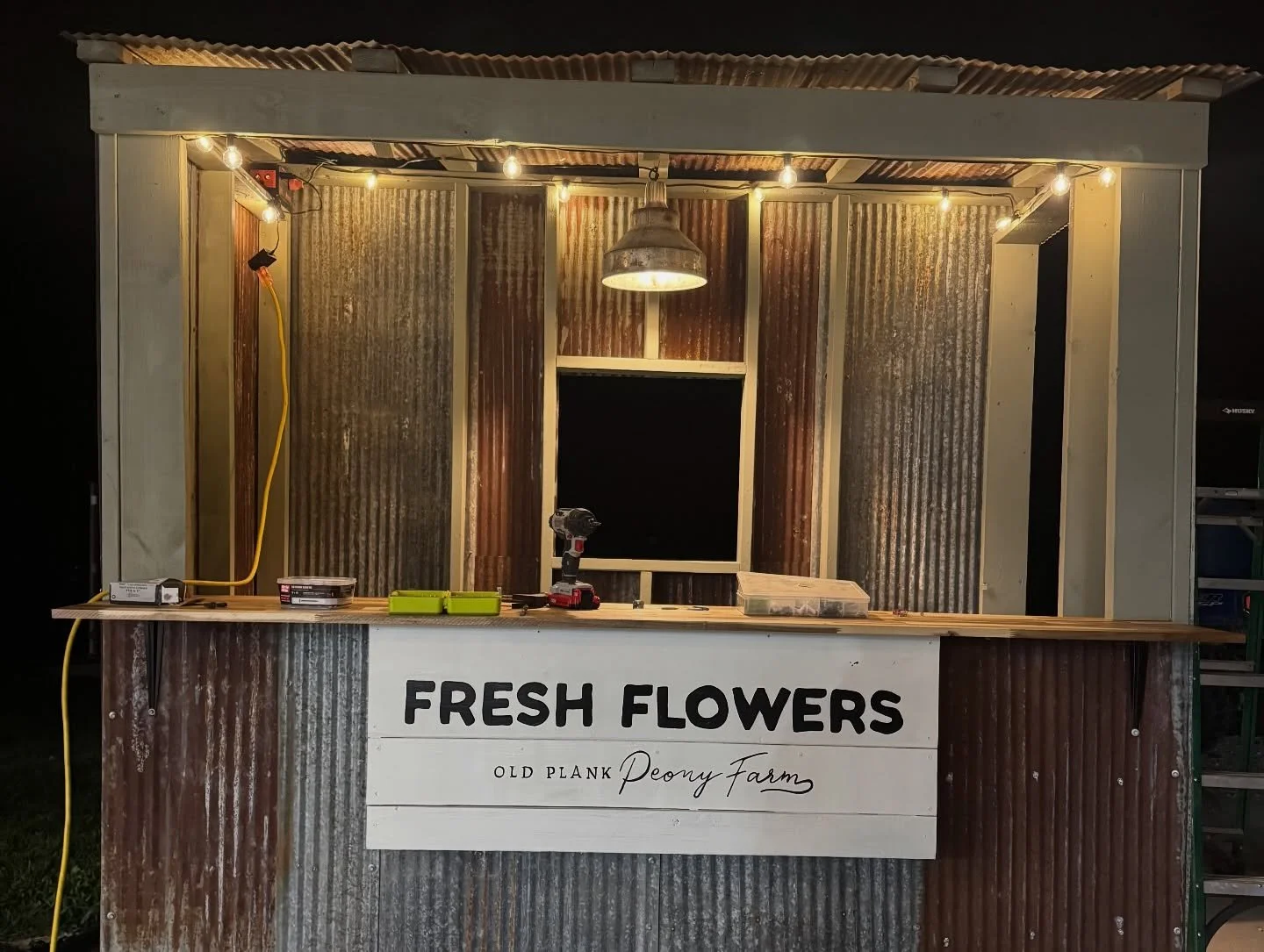 I made a flower stand! Out of a chicken coop! Still working out how to merchandise the flowers (wraps and jars). Should it just be a front-facing counter, or have folks walk in the door to shop? 

I still had a lot of details and shelves to add, but 