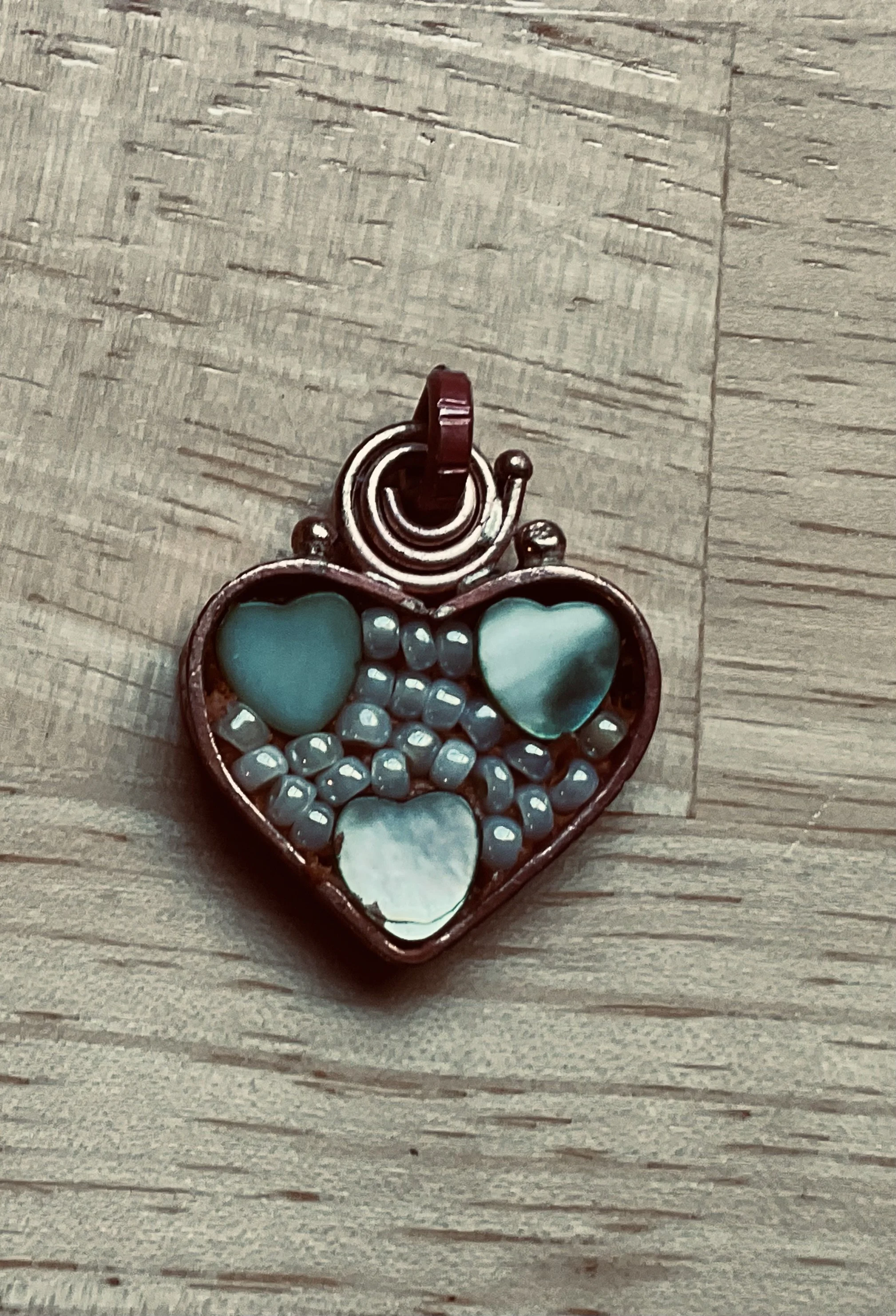 Copper heart with pearls and shell hearts.
