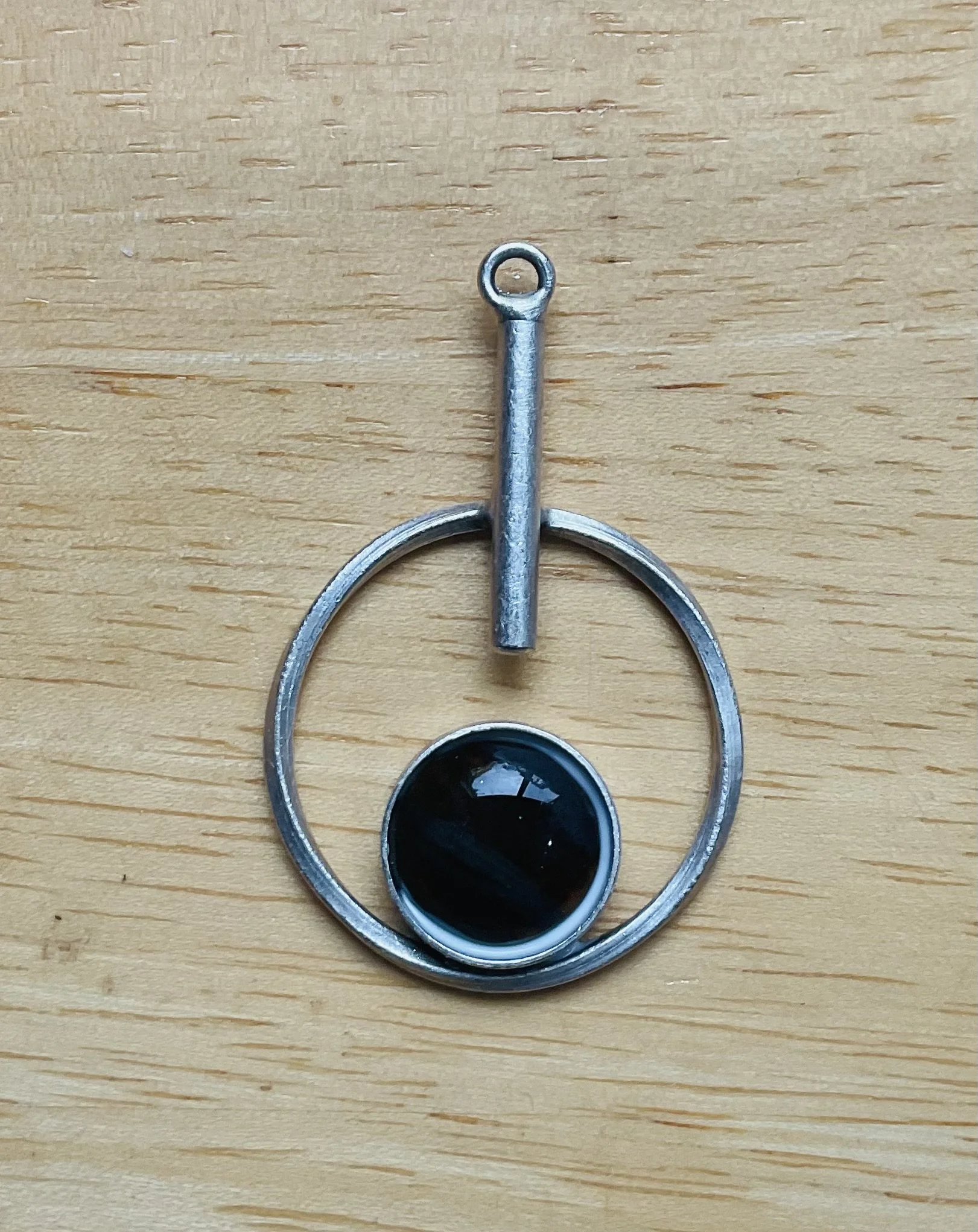 Silver coloured metal pendant with fused glass