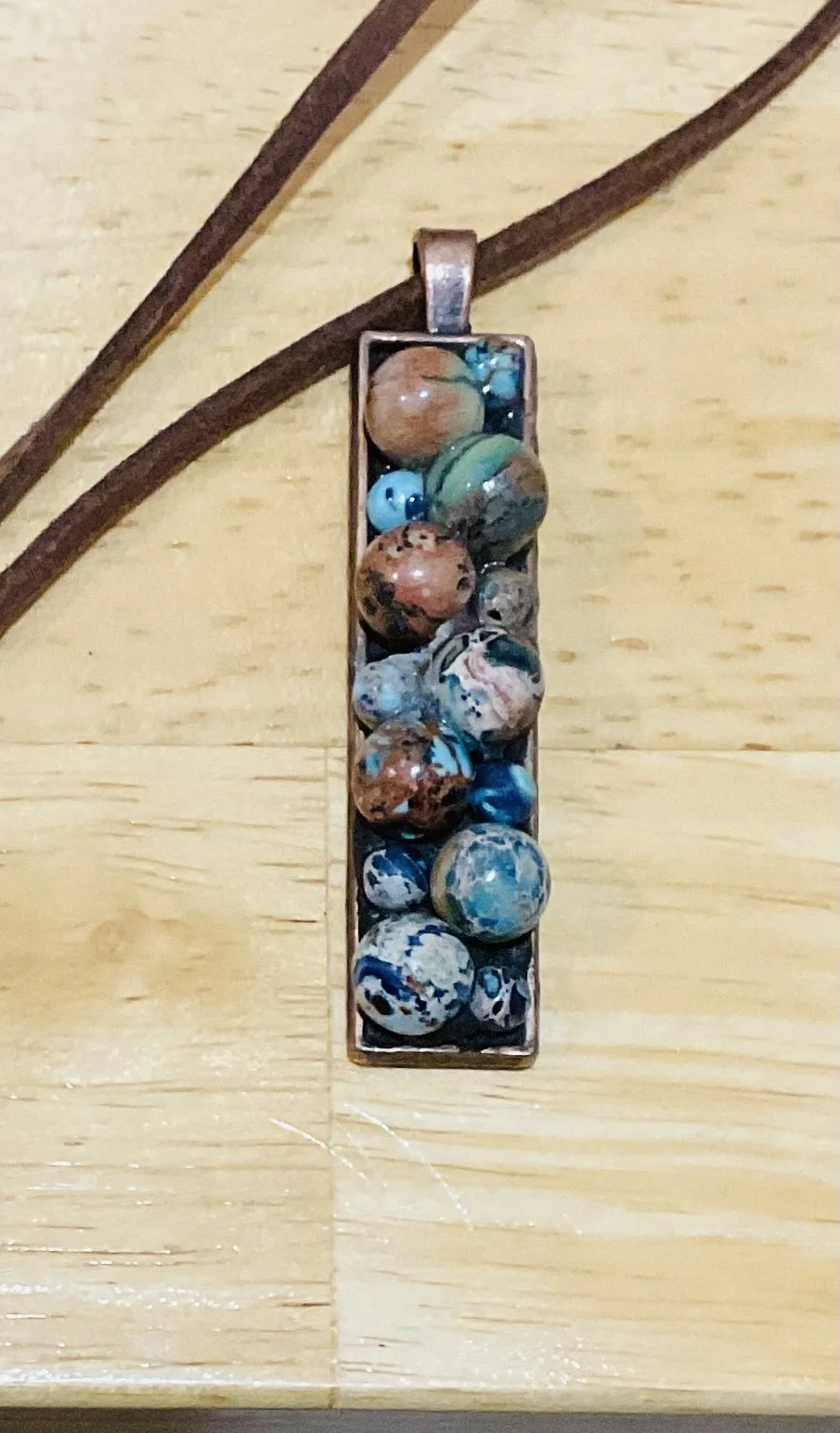 Copper finish pendent 50x12mm fill With natural blue beads