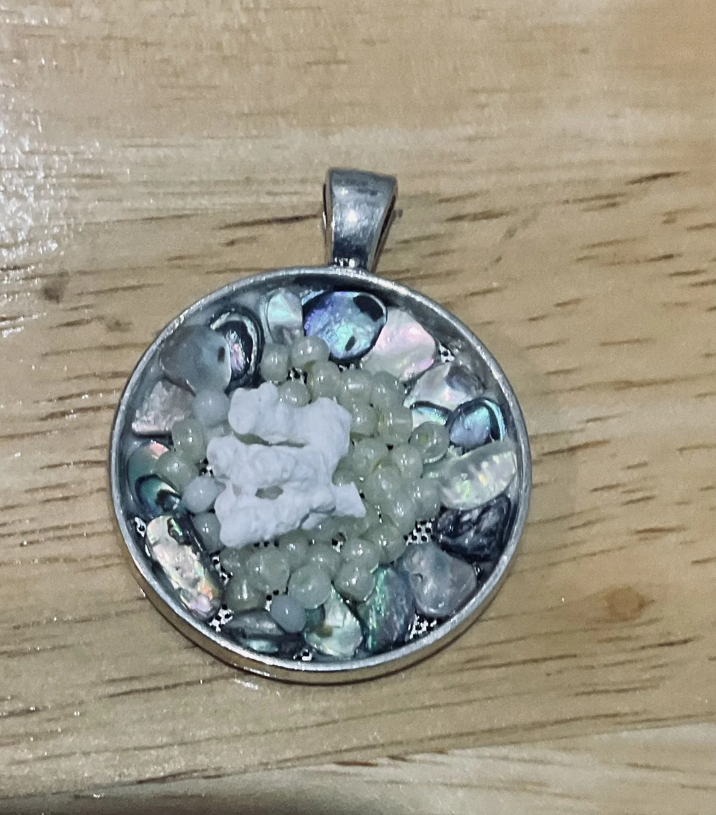 Silver plated pendant 20 mm filled with abalone shells pearls and coral. 