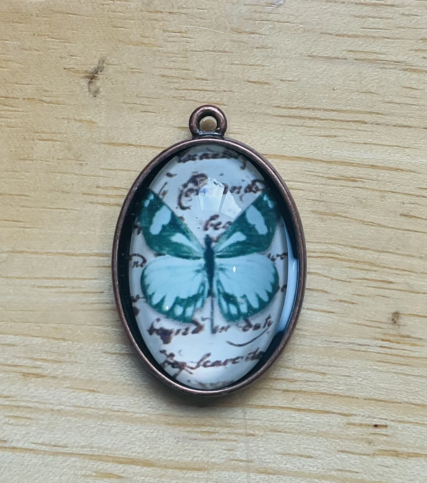 Silver coloured metal pendant 25mm filled with a butterfly cabochon