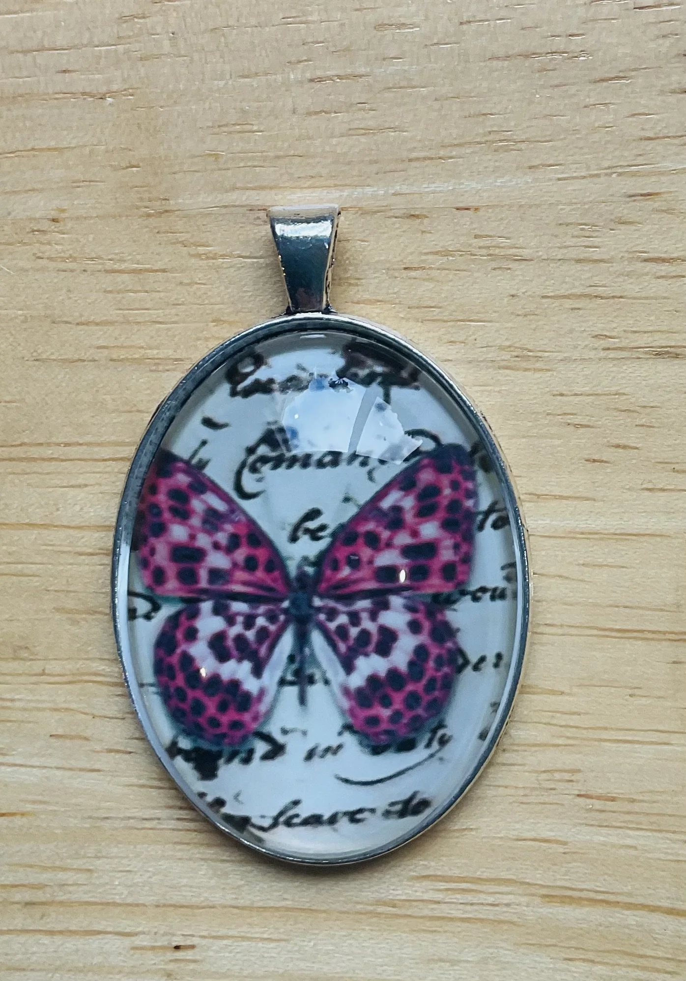 Silver coloured pendant 40mm filled with a butterfly cabochon