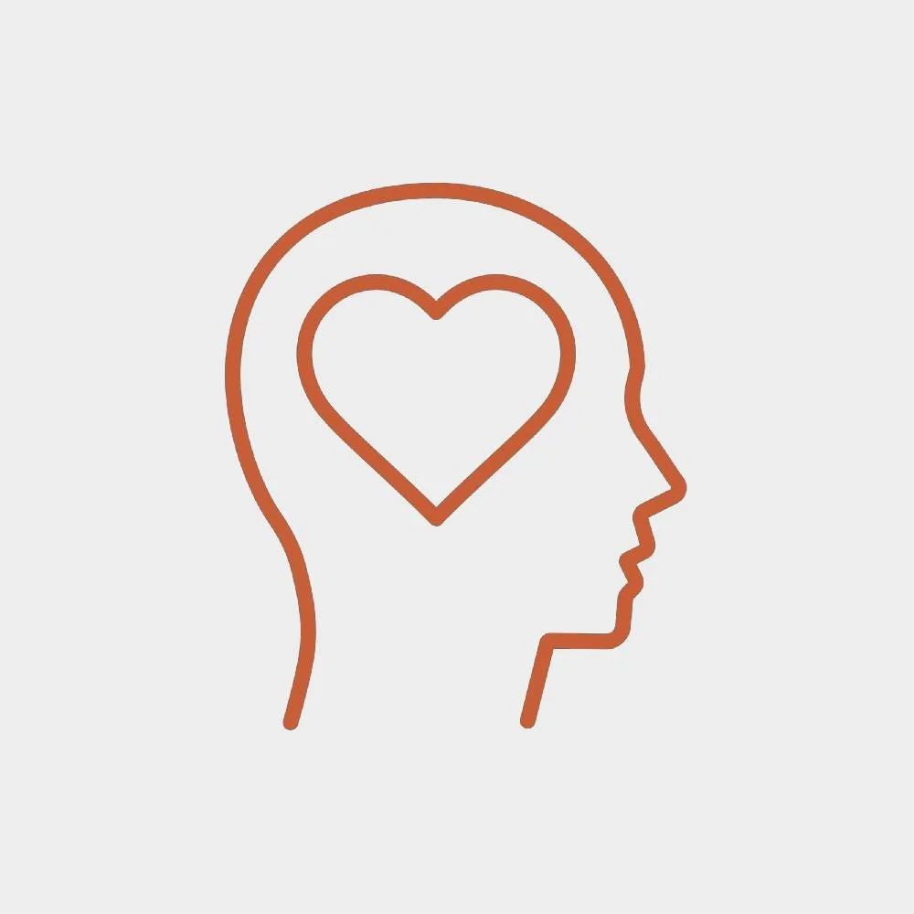 Outline of a person's head in profile with a heart inside the brain area.