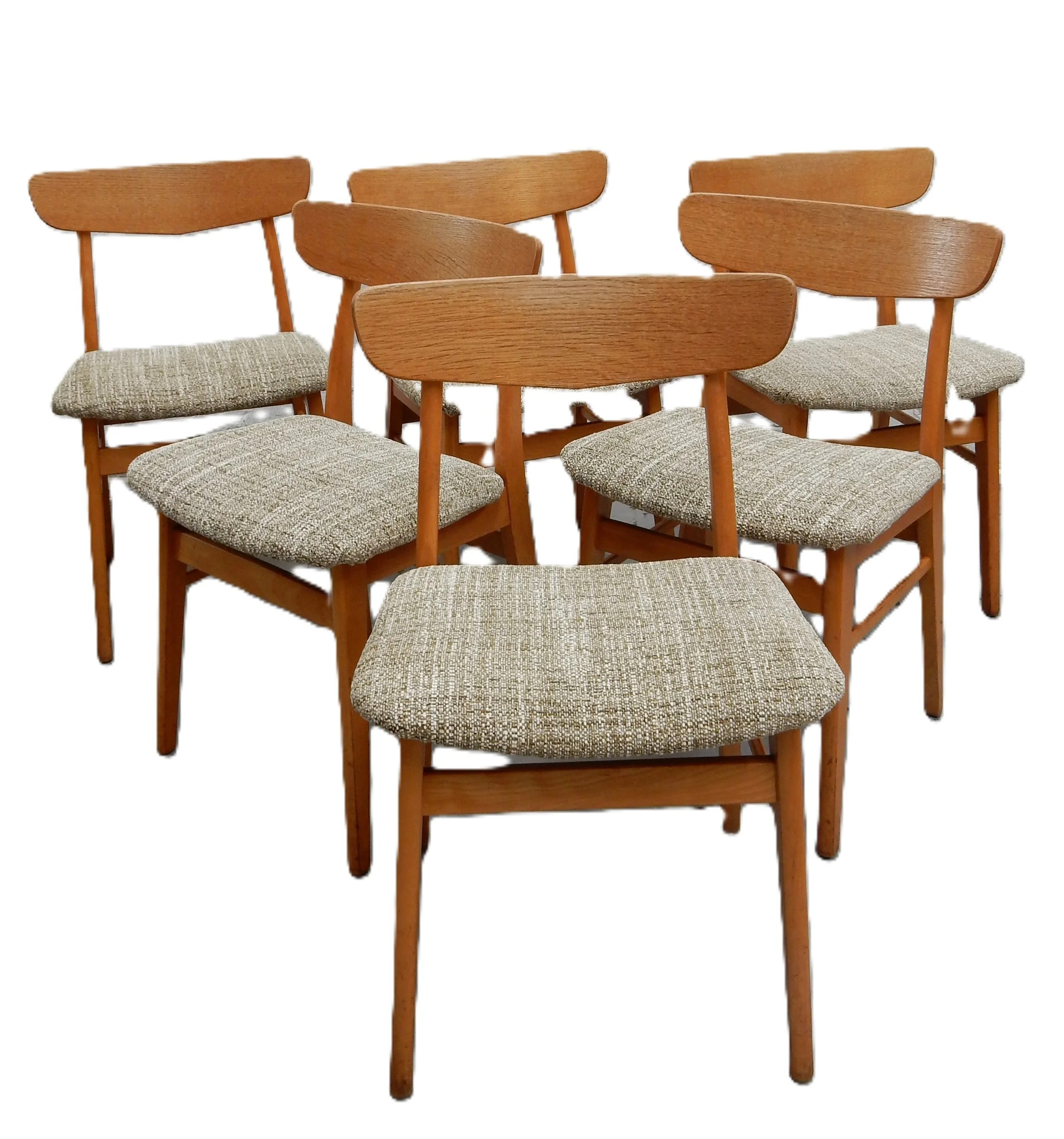 Set of six wooden chairs with upholstered seats arranged in a semi-circle.