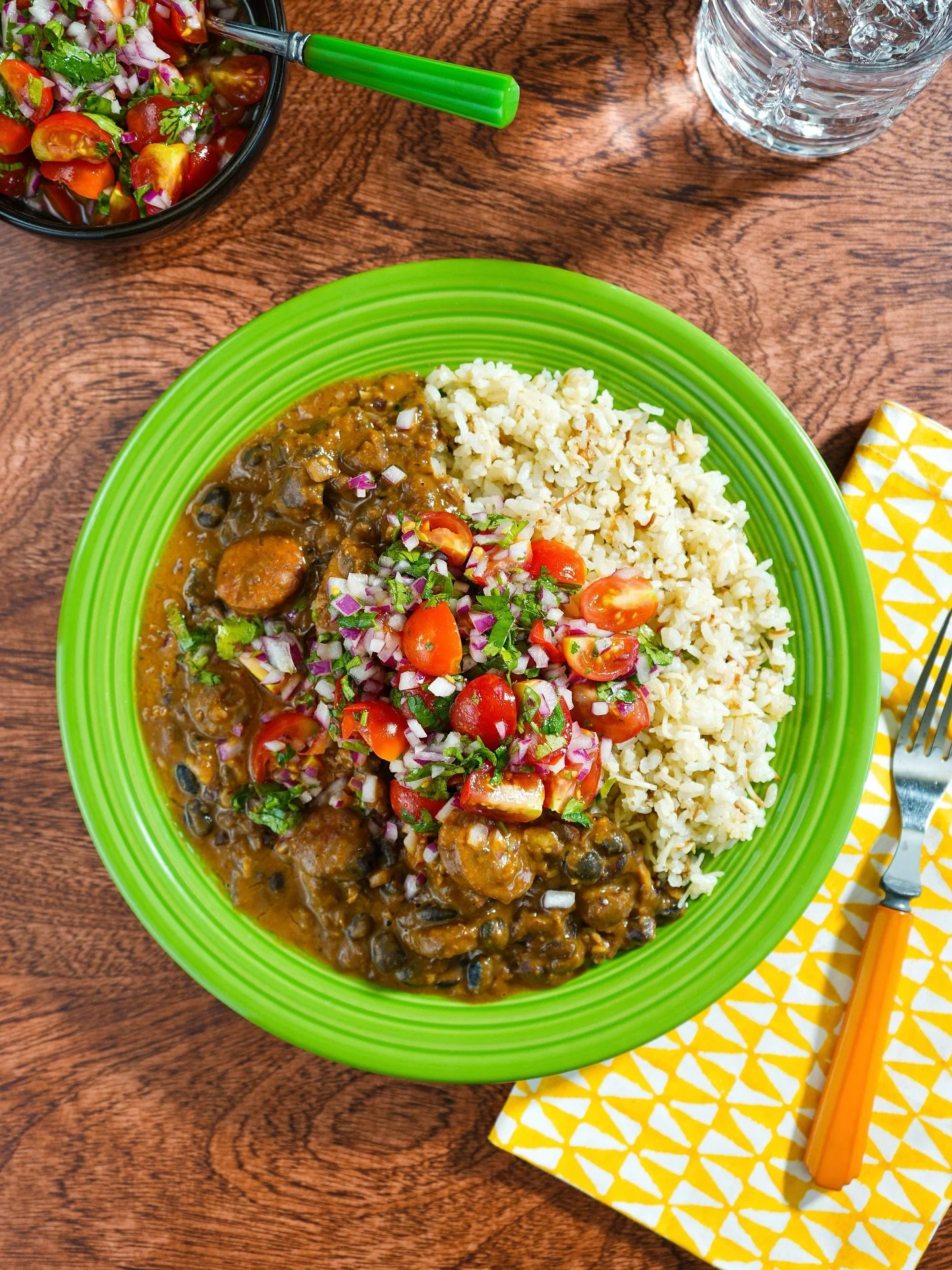 A Brazilian feijoada&ndash;inspired plate made from meaty odds and ends in the freezer, including Portuguese sausage and an assortment of beans, with limey arroz con fideos and a cherry tomato salsa.

Growing up, our family took countless summer road