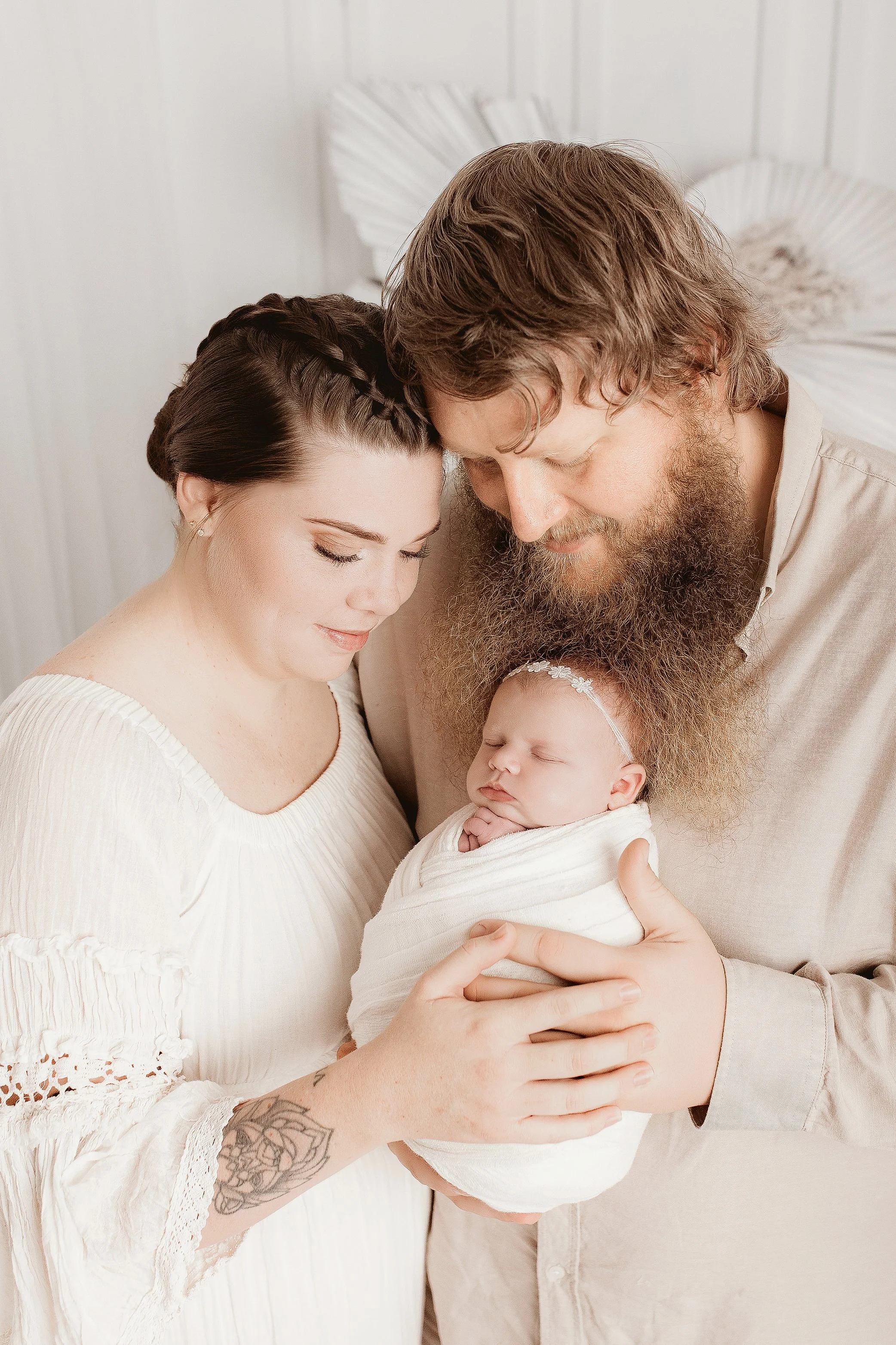 Newborn baby with parents during relaxed Ipswich newborn photography session