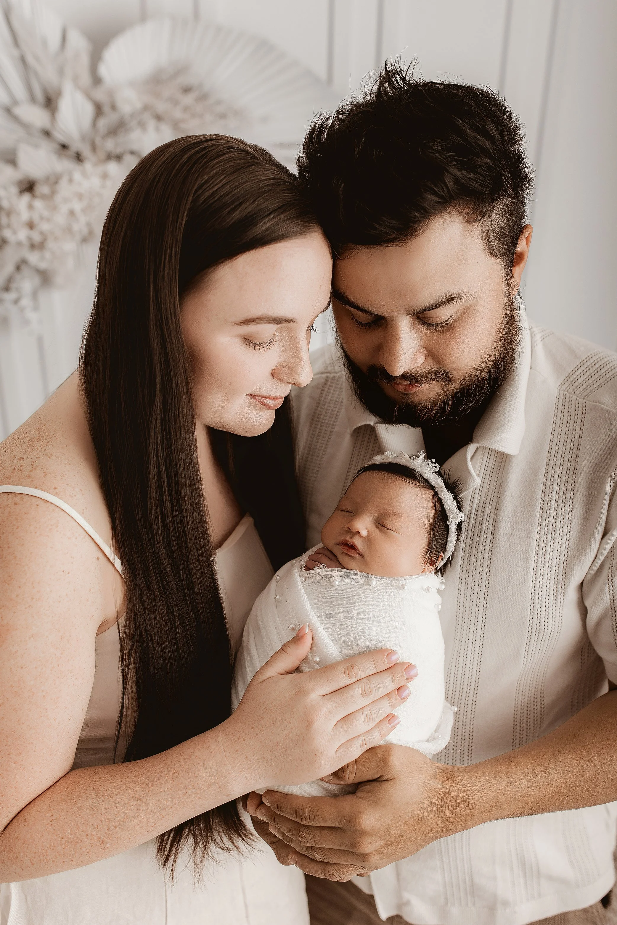 Family of three with newborn baby captured in Ipswich photography studio