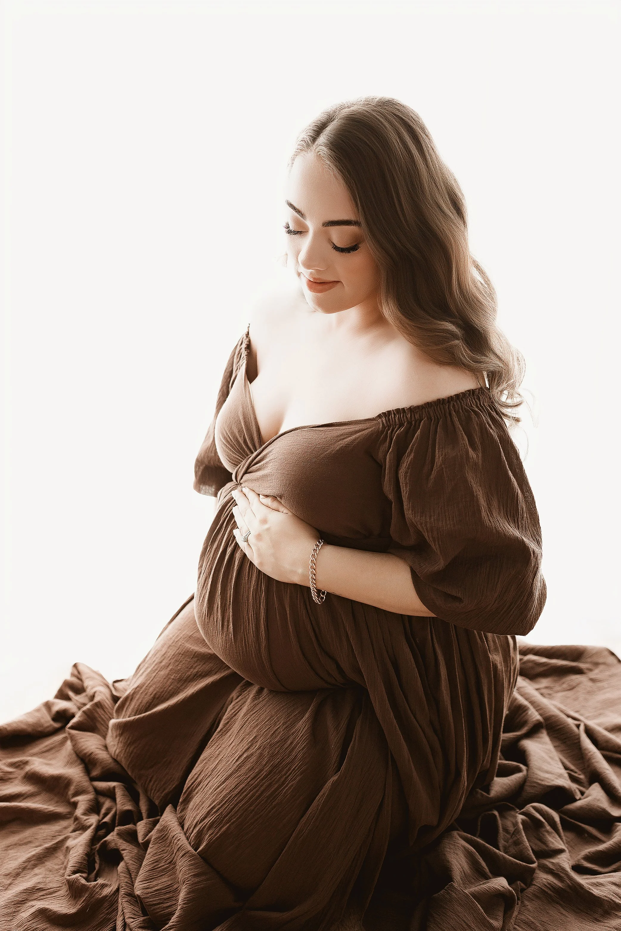 Timeless studio maternity photo with neutral styling in Ipswich