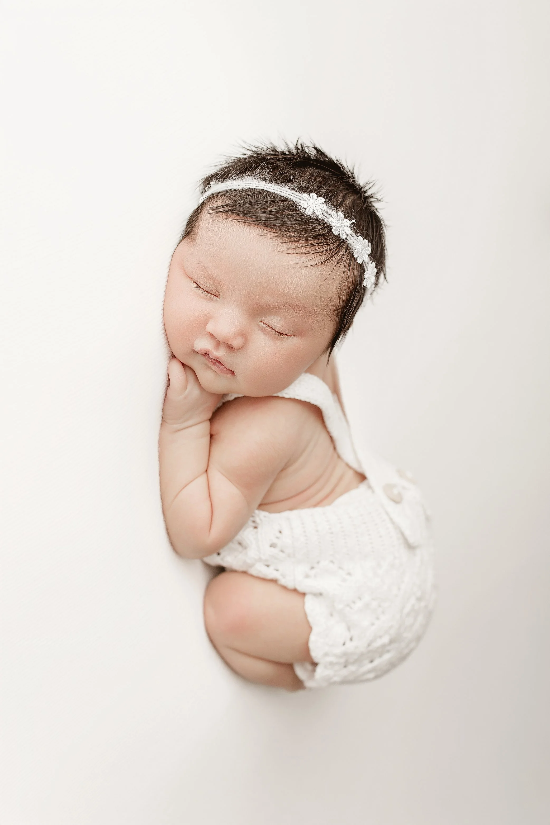 Newborn baby photographed in neutral studio setup by Ipswich Queensland photographer