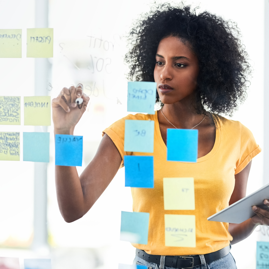 Photo of a woman mapping out an action plan with post its