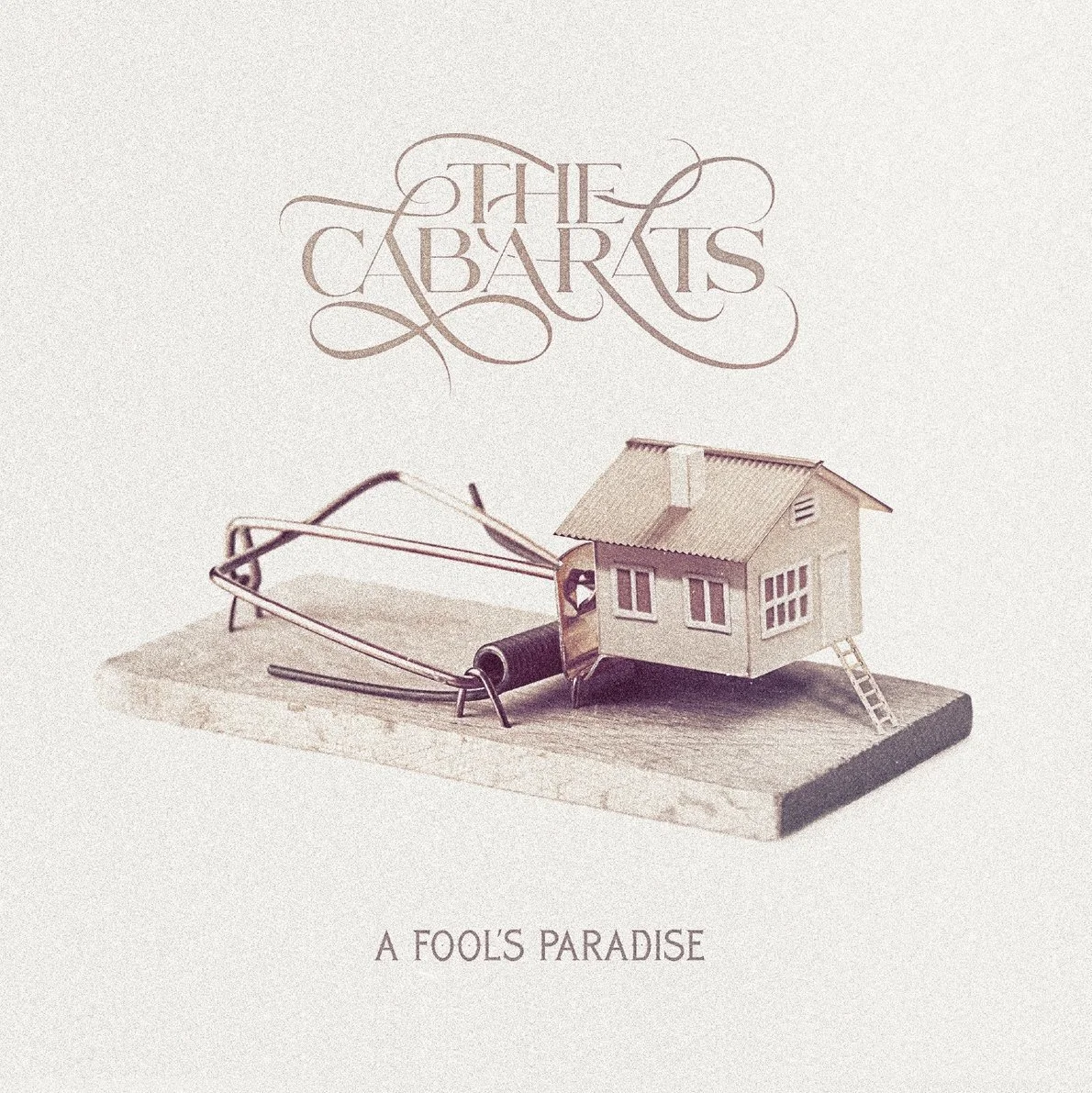 Album cover for The Cabaret's 'A Fool's Paradise,' with a paper house on a mousetrap against a plain background, featuring elegant text.
