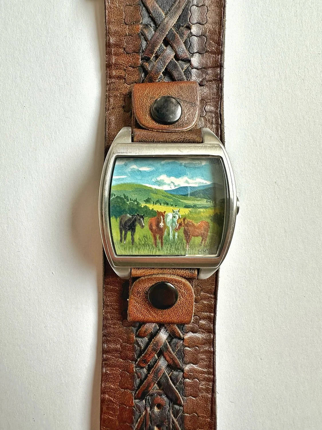 Detail of art bracelet with horses. 
