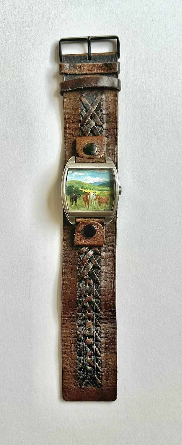 Full band view of art bracelet with horses.