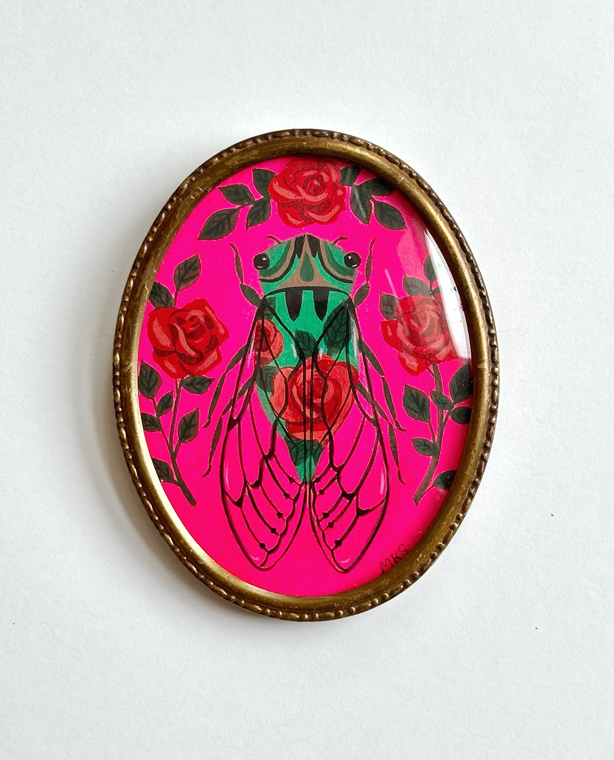 Miniature gouache cicada with roses in oval frame.