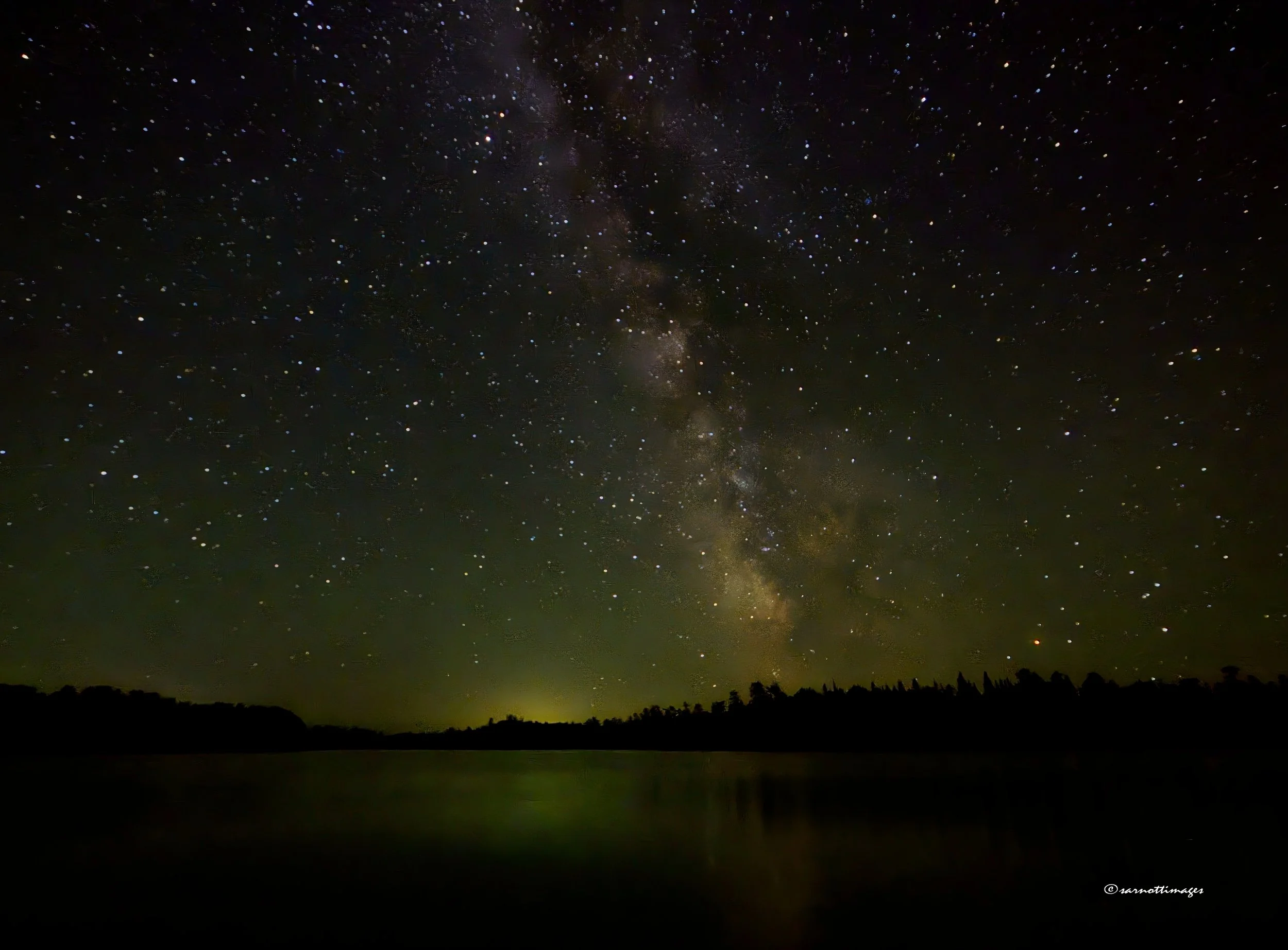 The Milky Way over Coon Lake in Scenic State Park, MN. There was a distant electrical storm, which added light to the horizon.