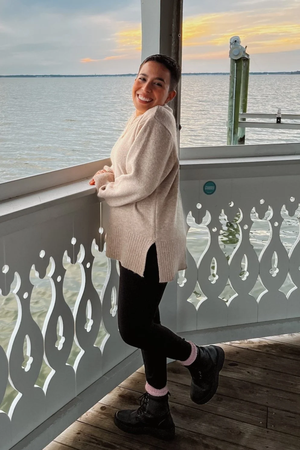 Latina artist and founder of Ember Studio smiling with water in the background, reflecting peace, creativity, and healing