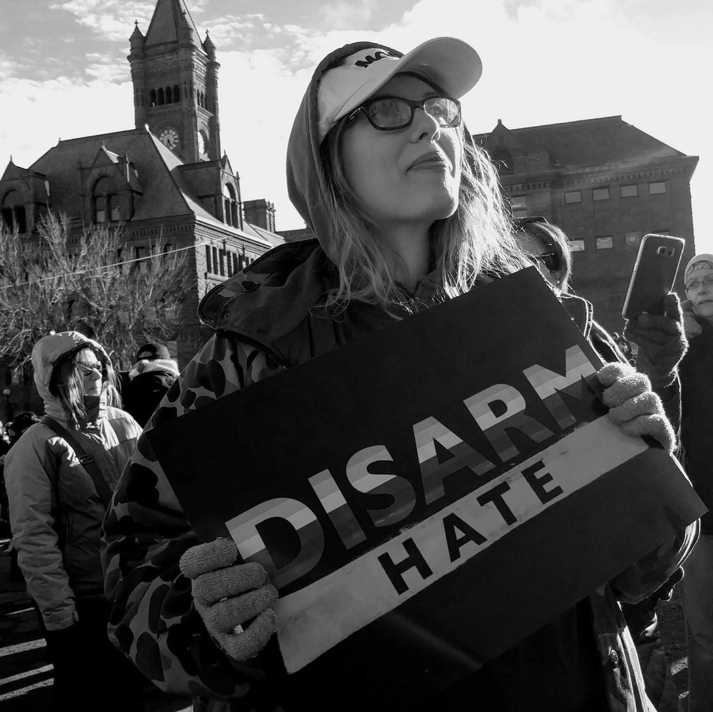 Aubrey L. holds a Disarm Hate poster while attending the 2019 March for Our Lives rally and march in Duluth, Minnesota