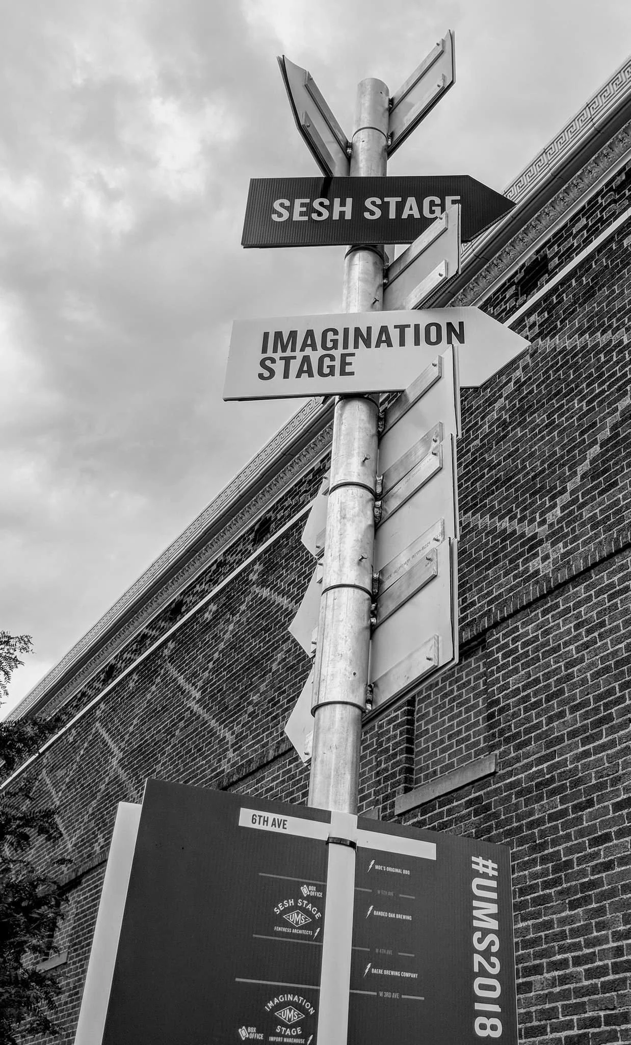 Labeled arrows pointing crowds to directions of stages for the Underground Music Showcase in Denver, Colorado