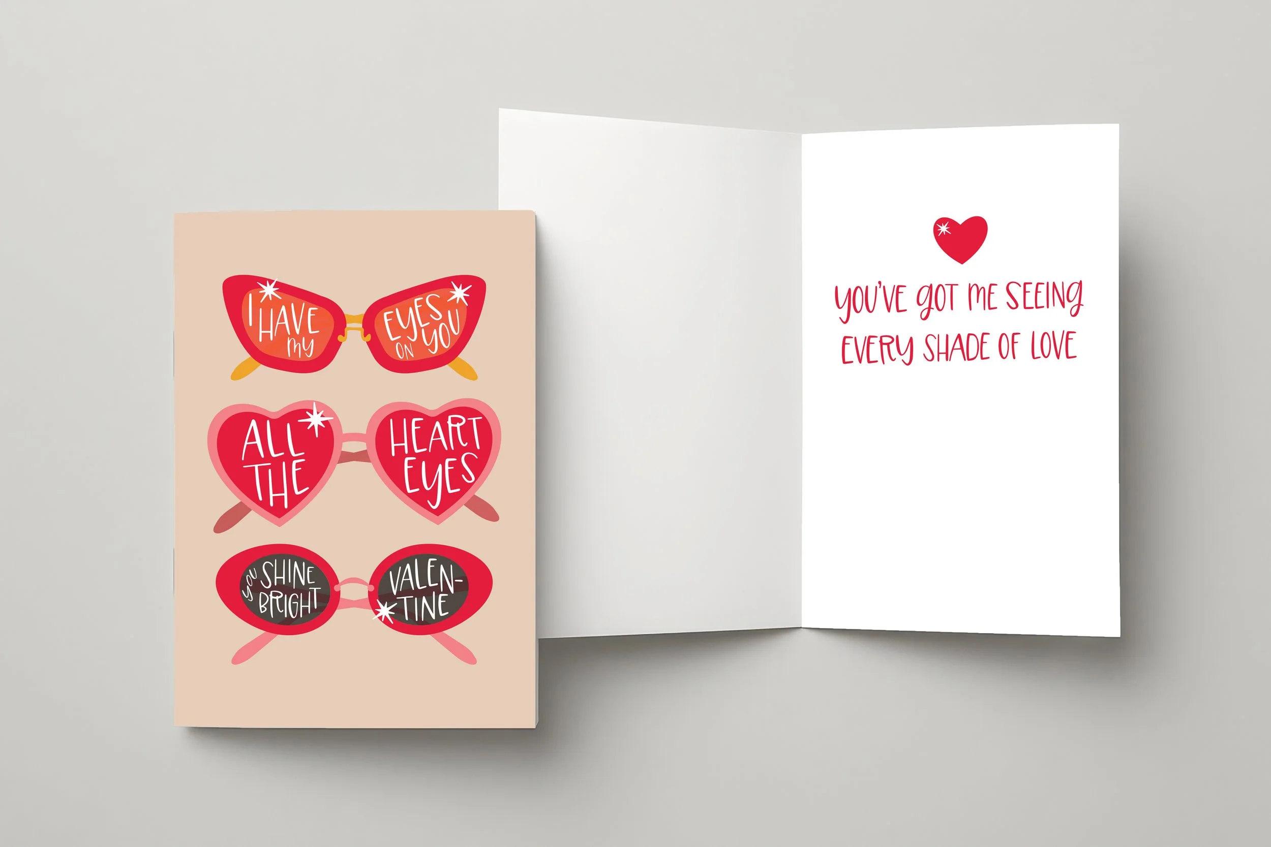 Valentine's Day greeting card collection featuring pink and red heart-shaped sunglasses with romantic puns including 'I have my eyes on you' and 'all the heart eyes