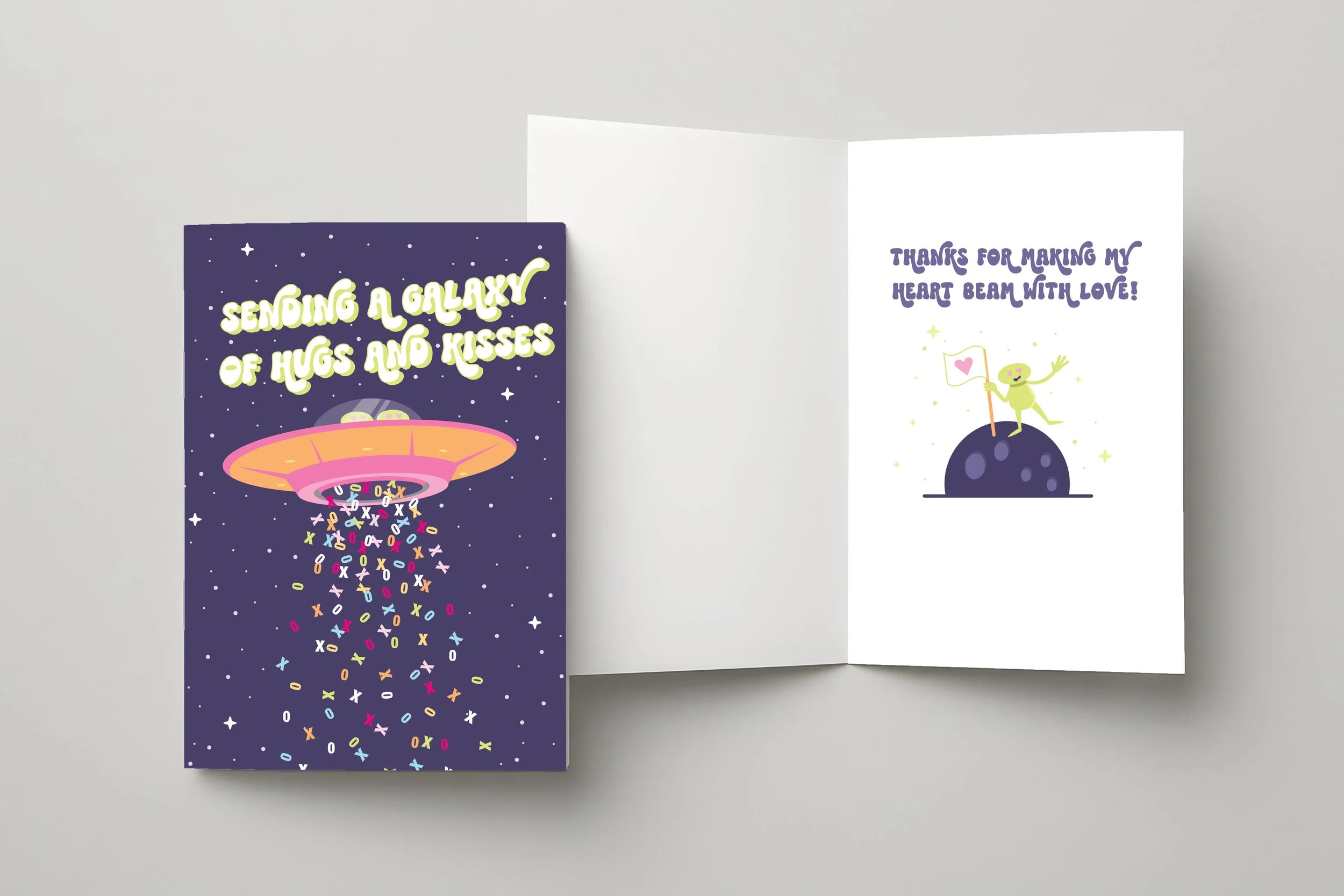 Valentine's Day card with UFO beaming colorful XO letters on starry space background, text reads 'Sending a galaxy of hugs and kisses,' inside shows alien on moon saying 'Thanks for making my heart beam with love