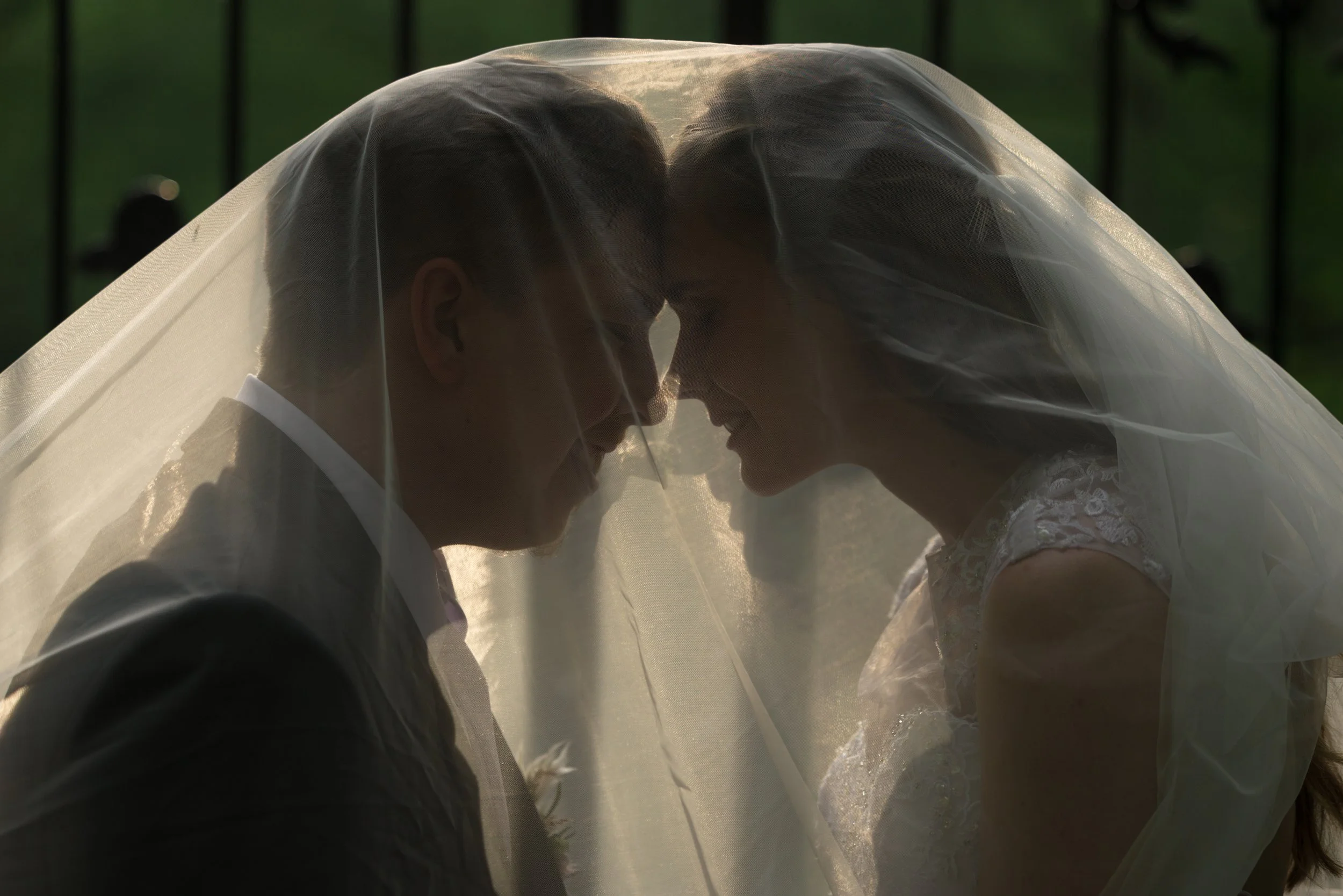 Bride and groom under the cathedral veil at Five Bridge Inn in Rehoboth, Massachusetts.