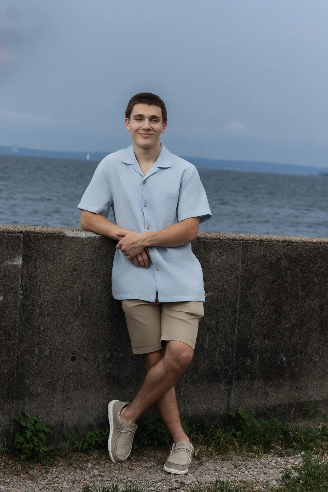High School senior boy with Narragansett Bay in the background at Rocky Point State Park in Warwick, Rhode Island.