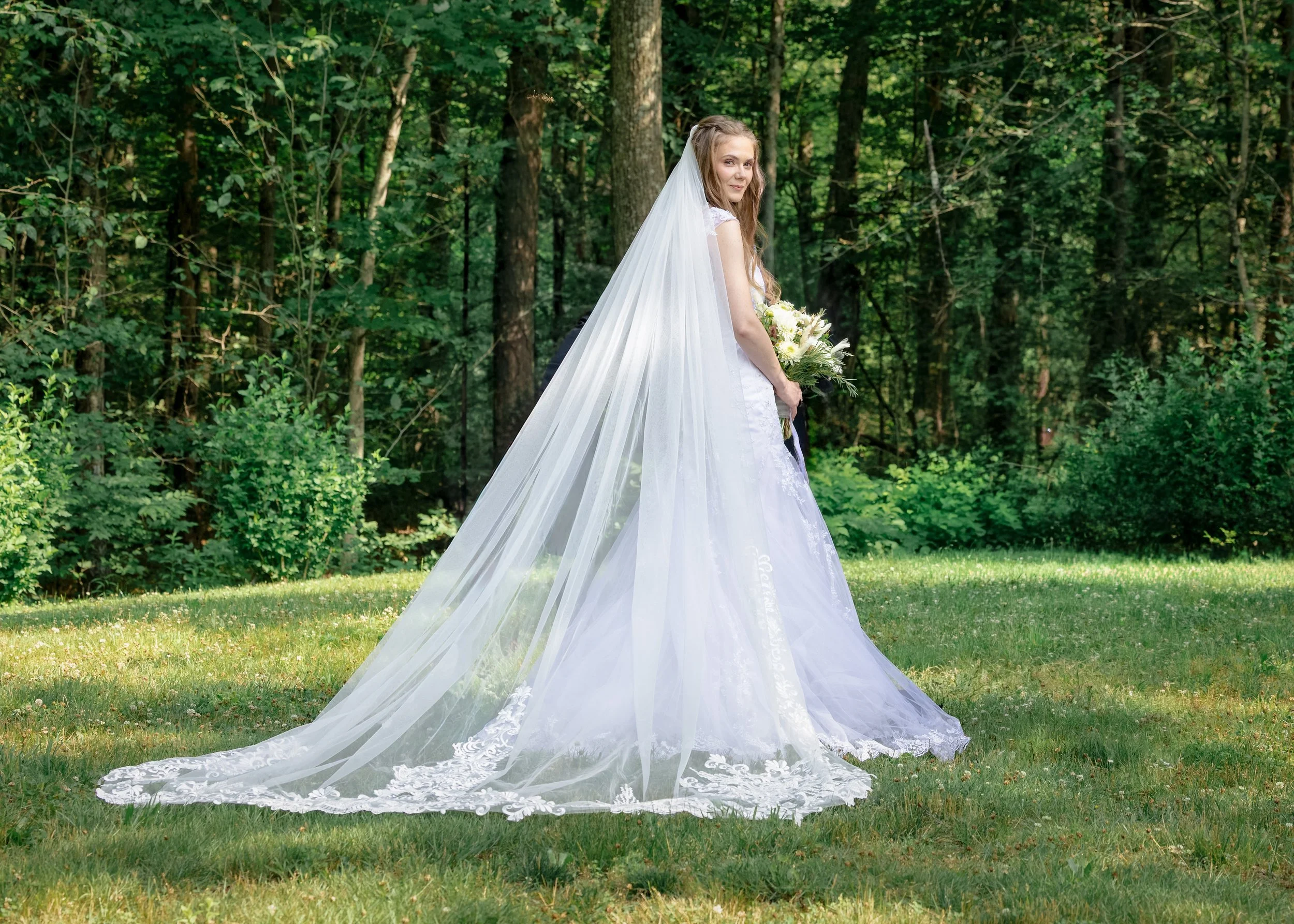 Bride standing in a long cathedral veil during wedding portraits at Five Bridge Inn in Rehoboth, Massachusetts.