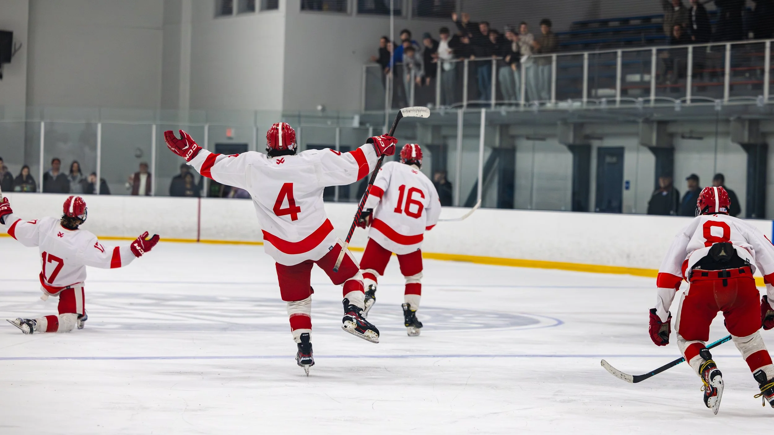 High school hockey team celebrating a goal during a game in Massachusetts